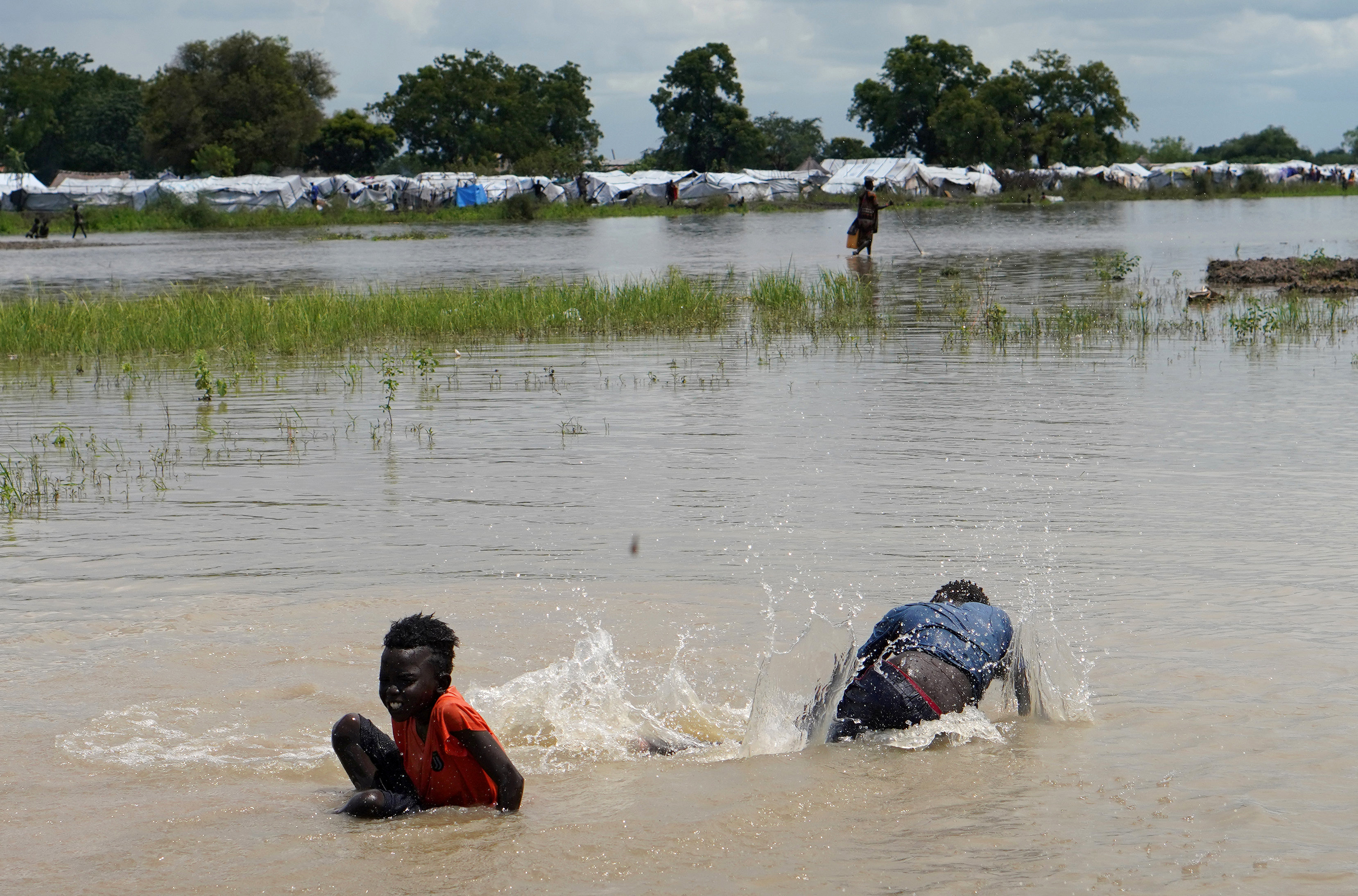Children play in floodwaters at the airstrip after the River Nile broke the dykes in Pibor