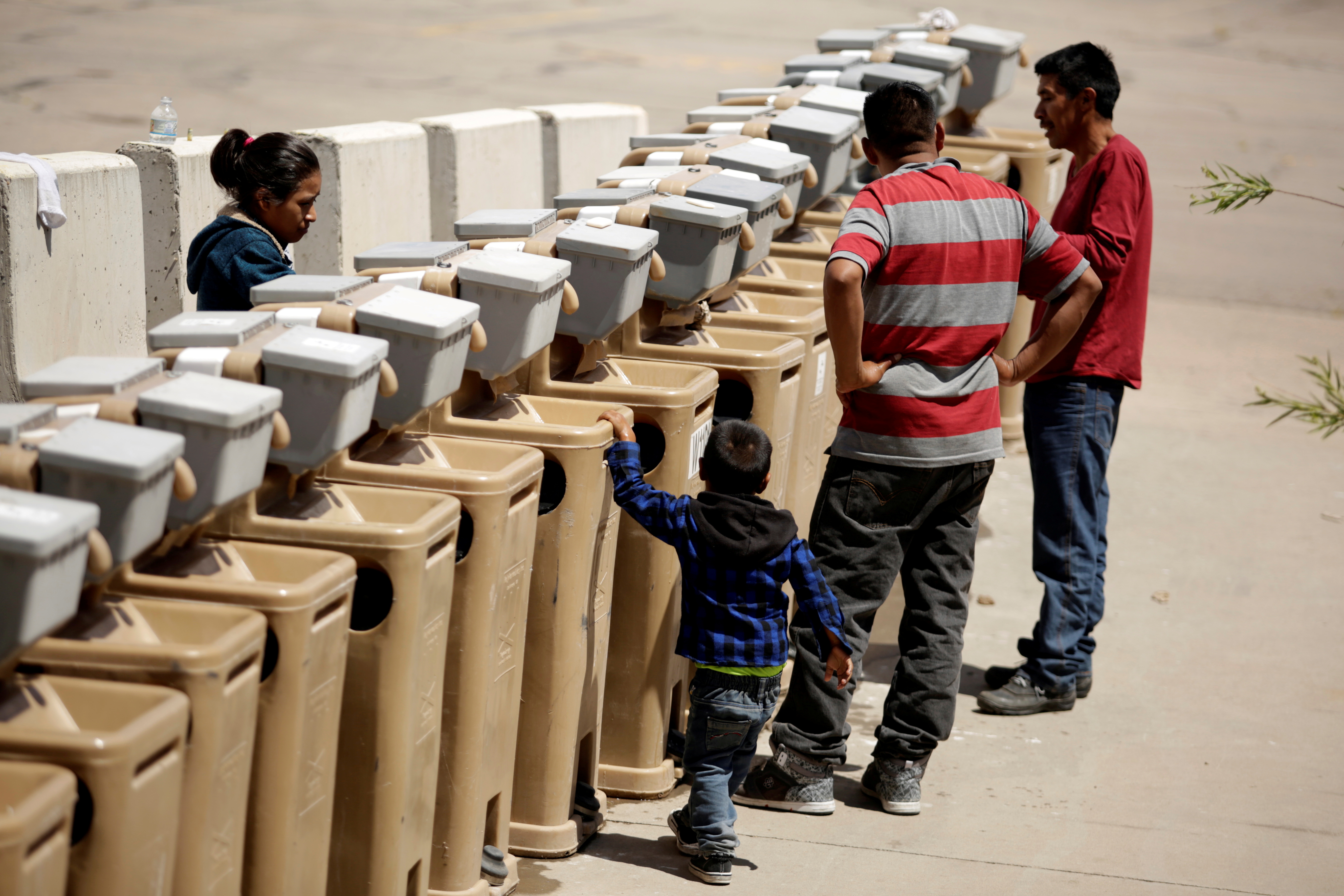 Migrants from Central America use the sinks at the