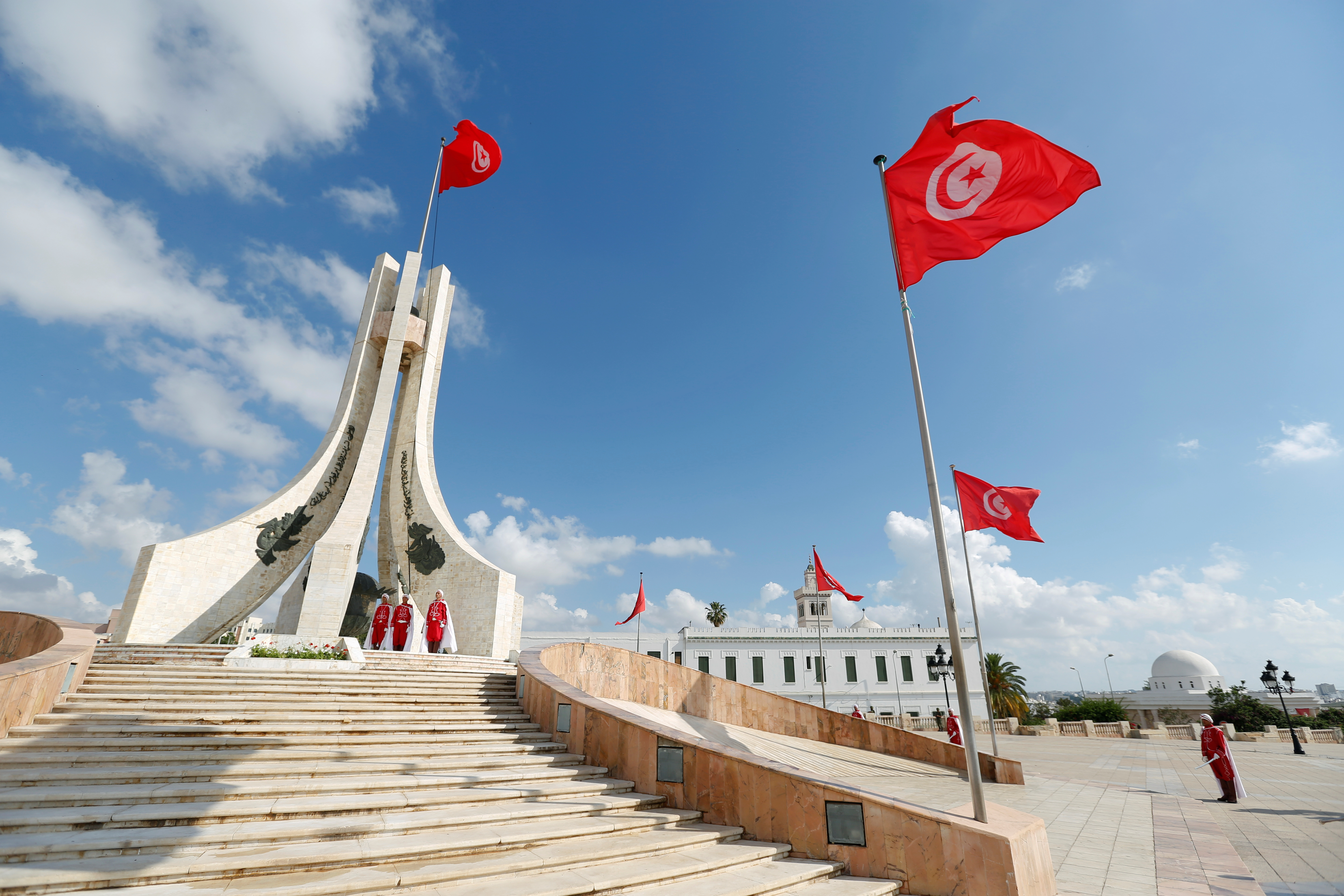 Members of the honour guard stand at attention during a flag raising in place of Kasba in Tunis