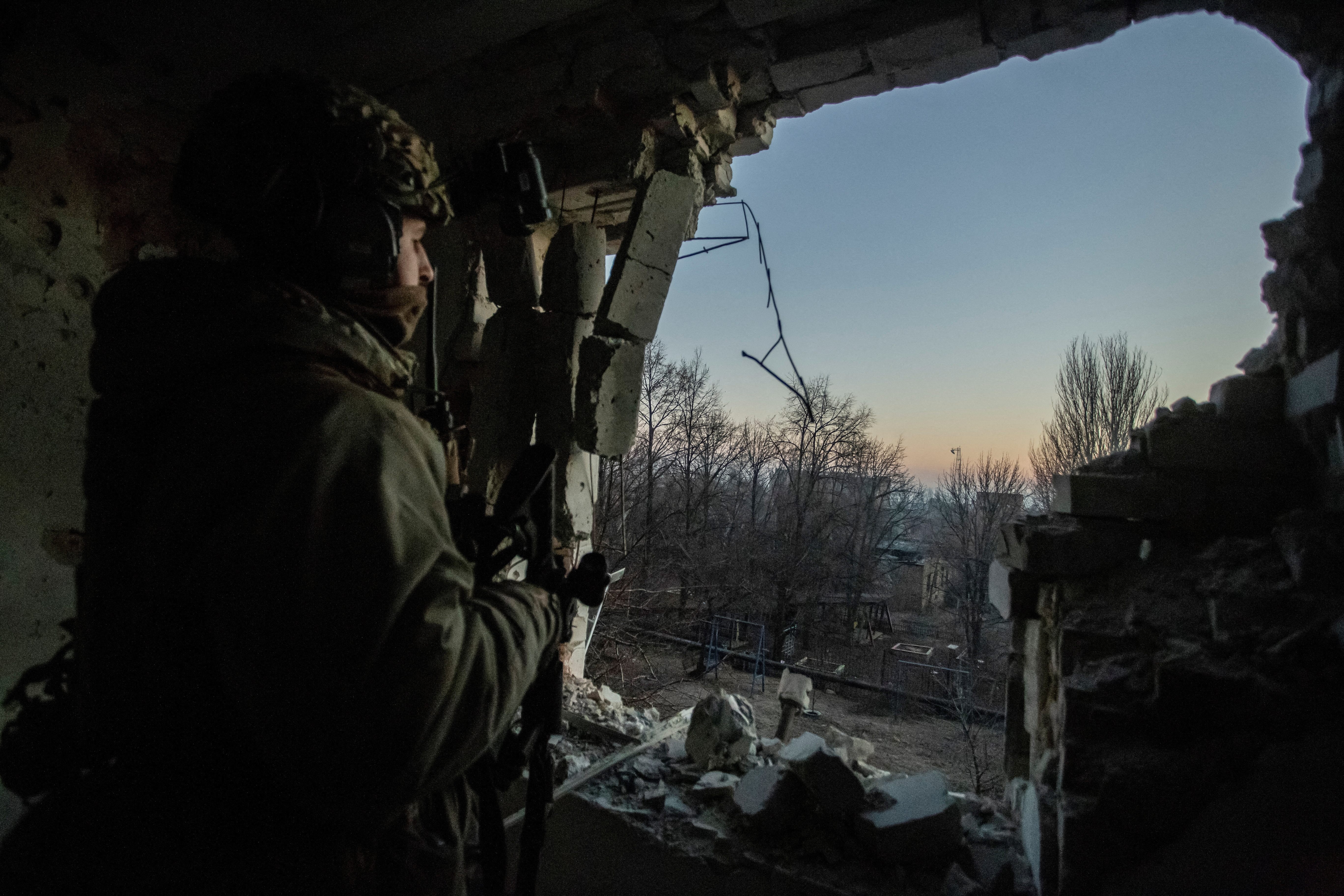 A Ukrainian serviceman looks on in Bakhmut