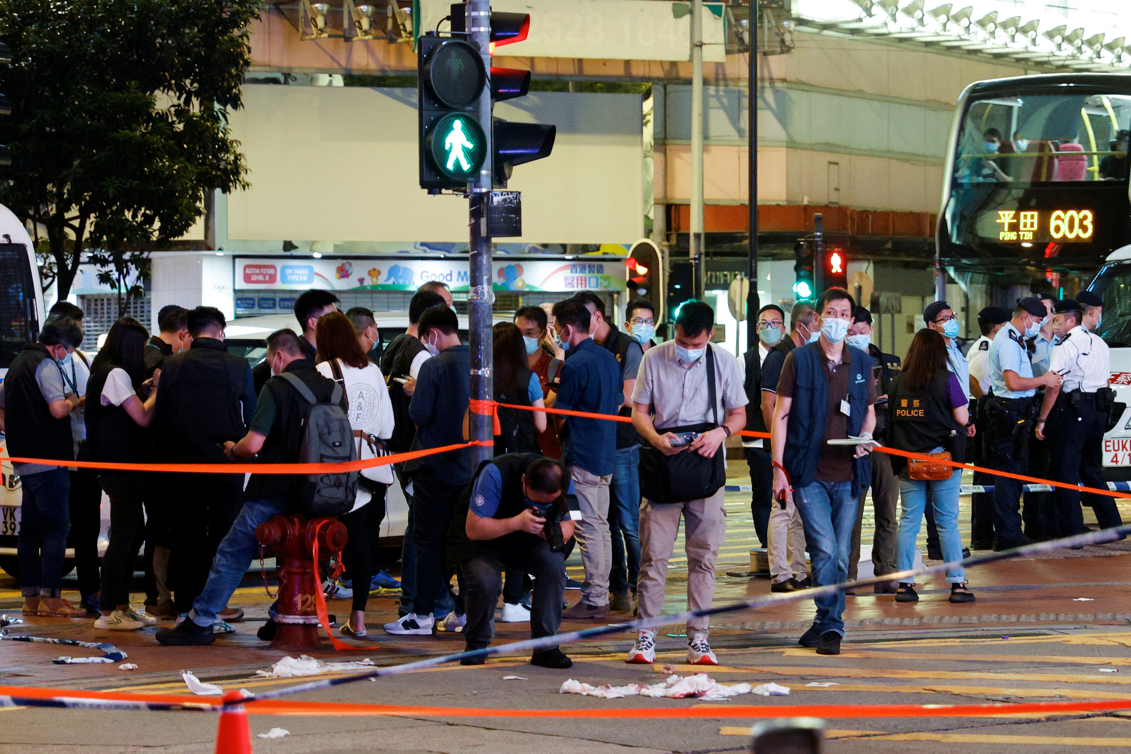Police take pictures at the site where a man allegedly stabbed a police officer, in Hong Kong