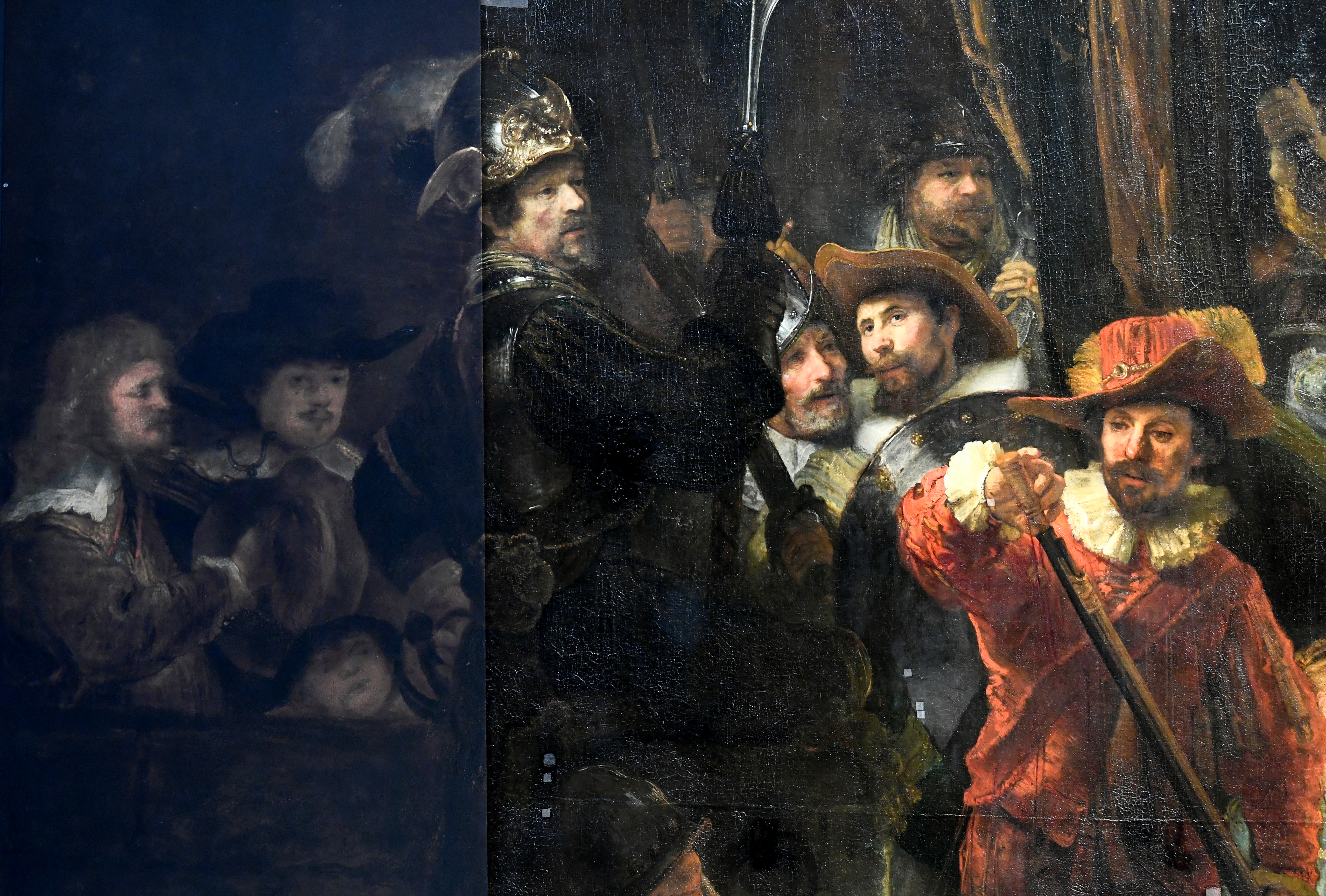 Rembrandt's famed Night Watch is seen back on display for the first time in 300 years, in what researchers say is its original size, with missing parts temporarily restored in an exhibition aided by artificial intelligence at Rijksmuseum in Amsterdam, Netherlands June 23, 2021. REUTERS/Piroschka van de Wouw 