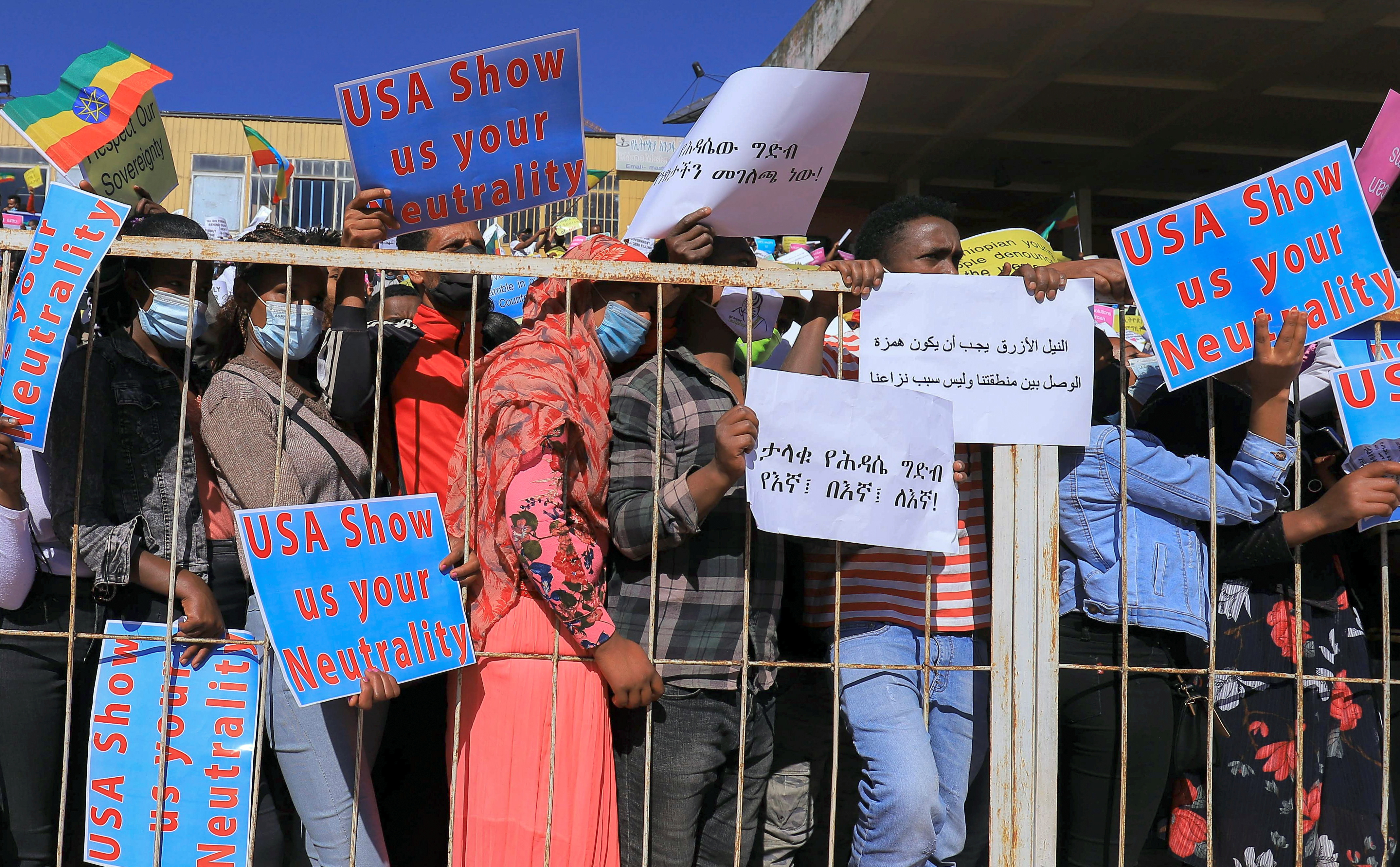 Ethiopian pro-government demonstrators carry placards as they attend a rally to protest against the U.S. action over alleged human rights abuses during the conflict in the Tigray region, in Addis Ababa