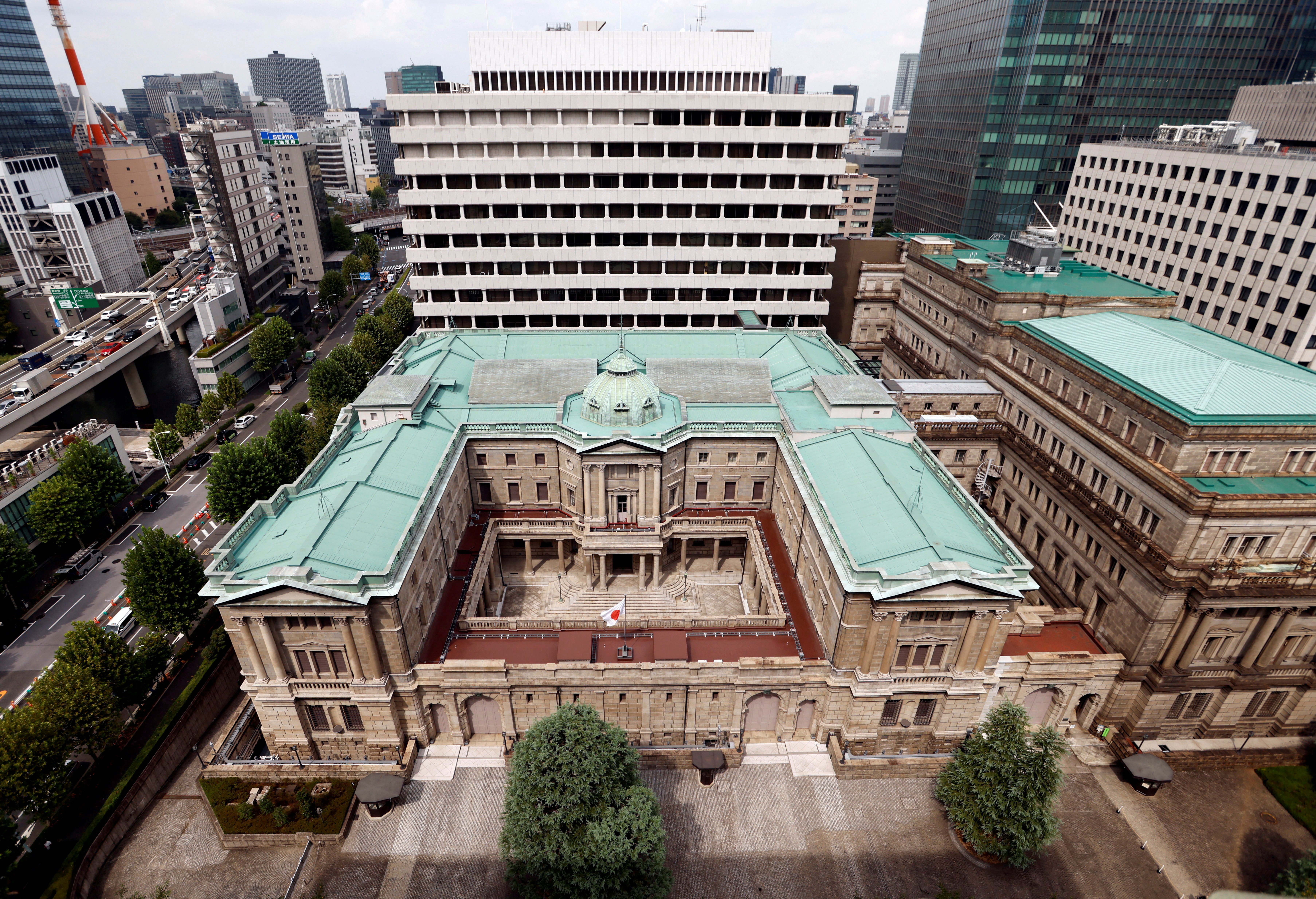 Japanese national flag is hoisted atop the headquarters of Bank of Japan in Tokyo