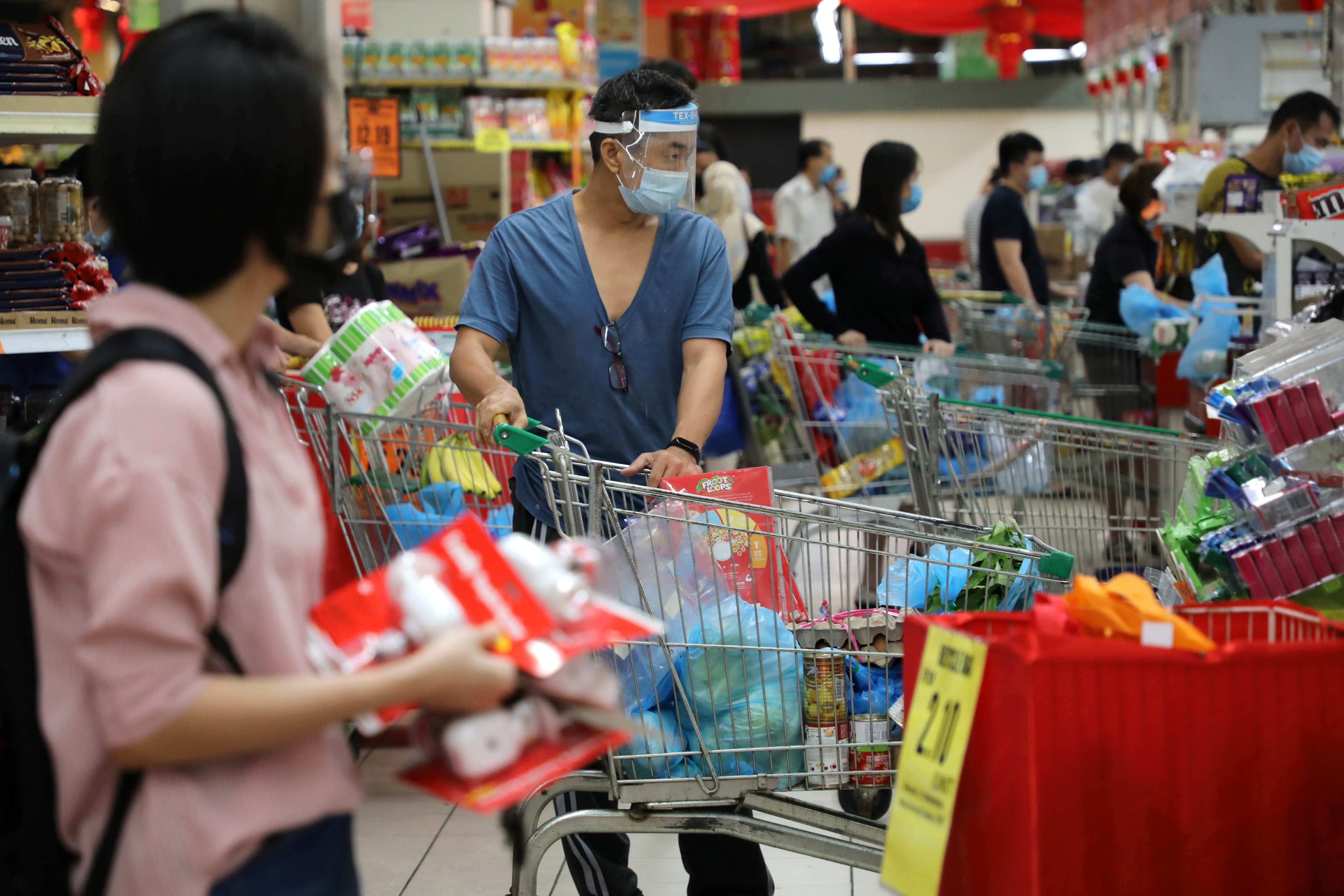 People line up to pay at a supermarket, amid the coronavirus disease (COVID-19) outbreak in Kuala Lumpur