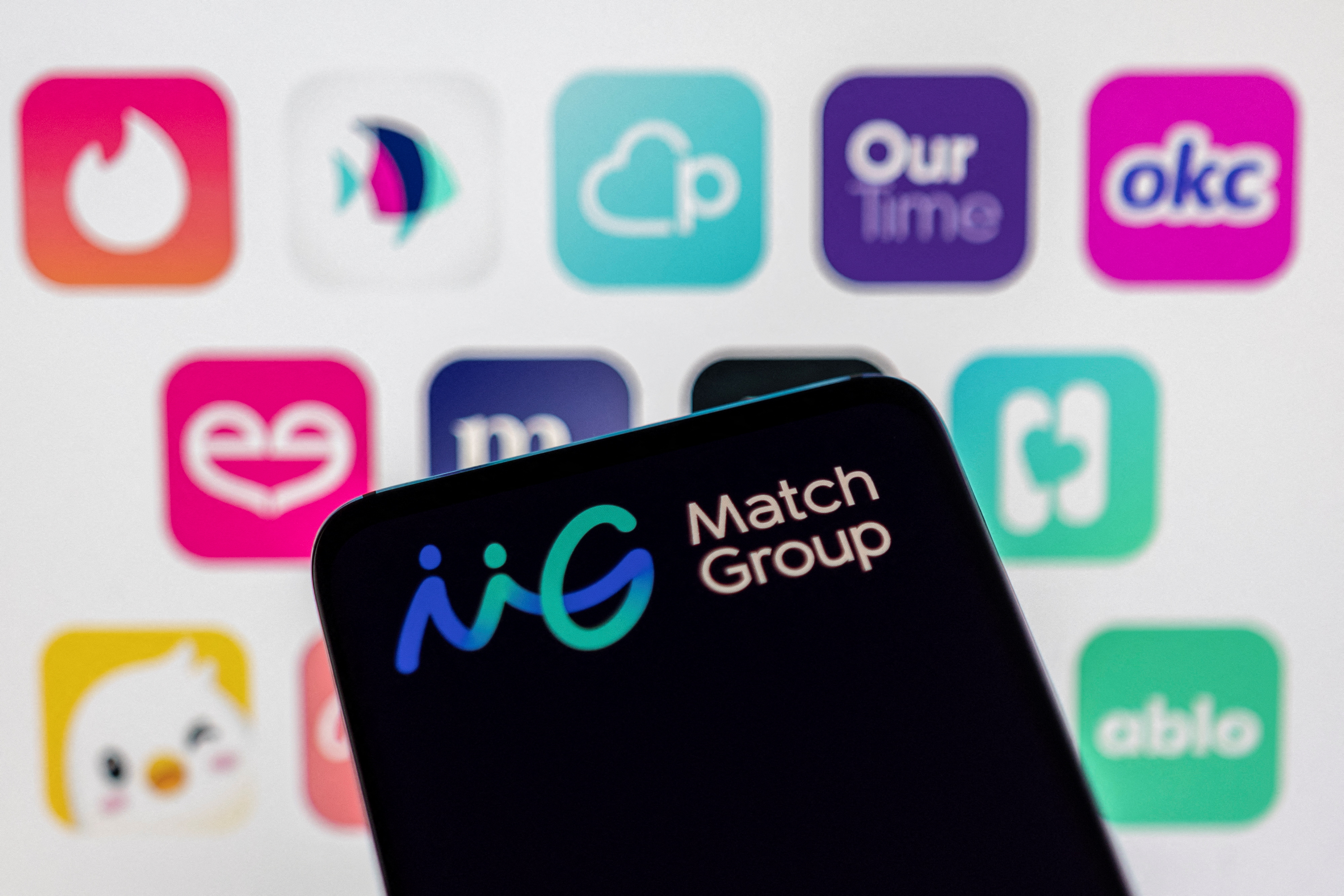 Illustration shows Match Group logo in front of their brands