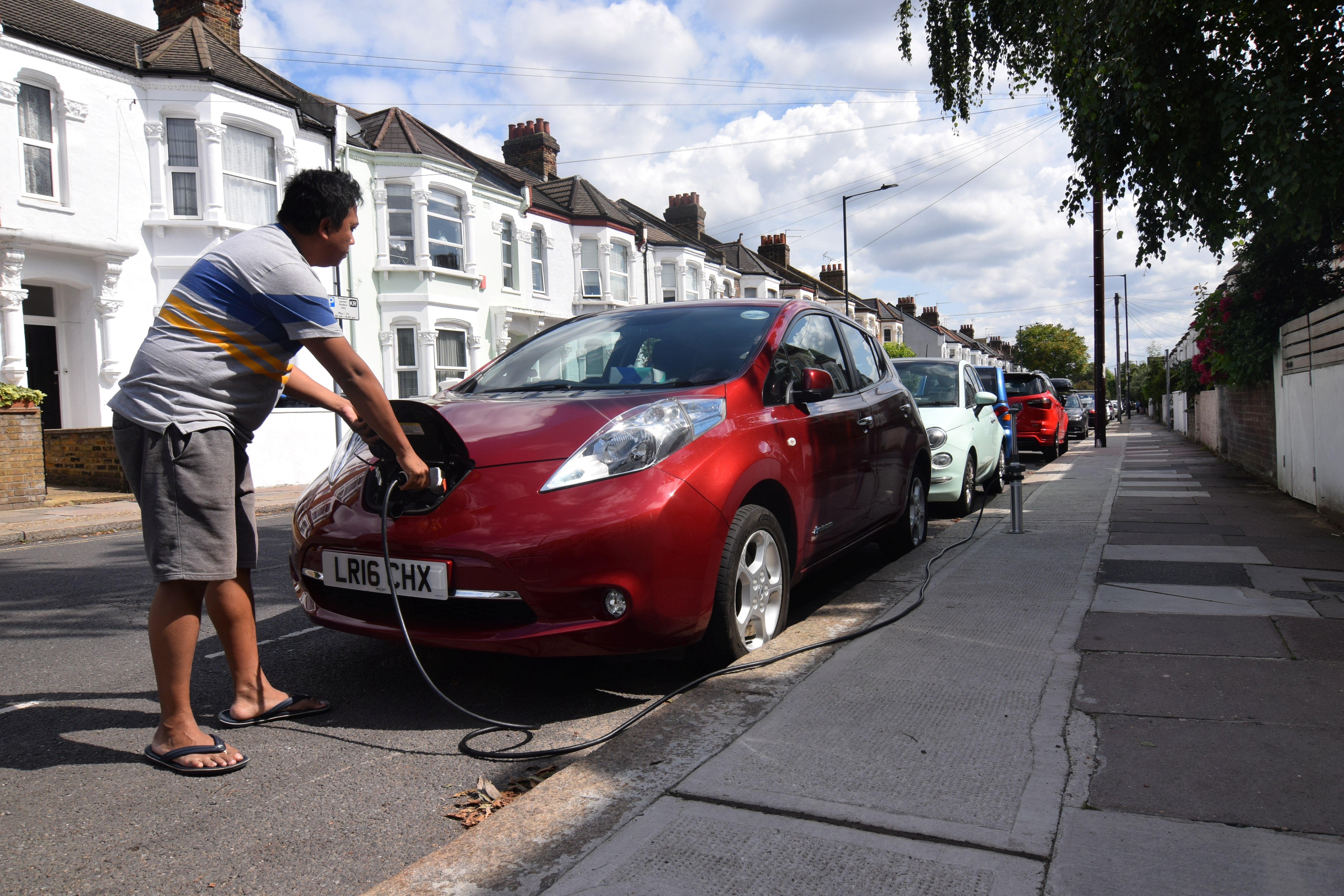 A Driver Charges His Nissan Leaf In London