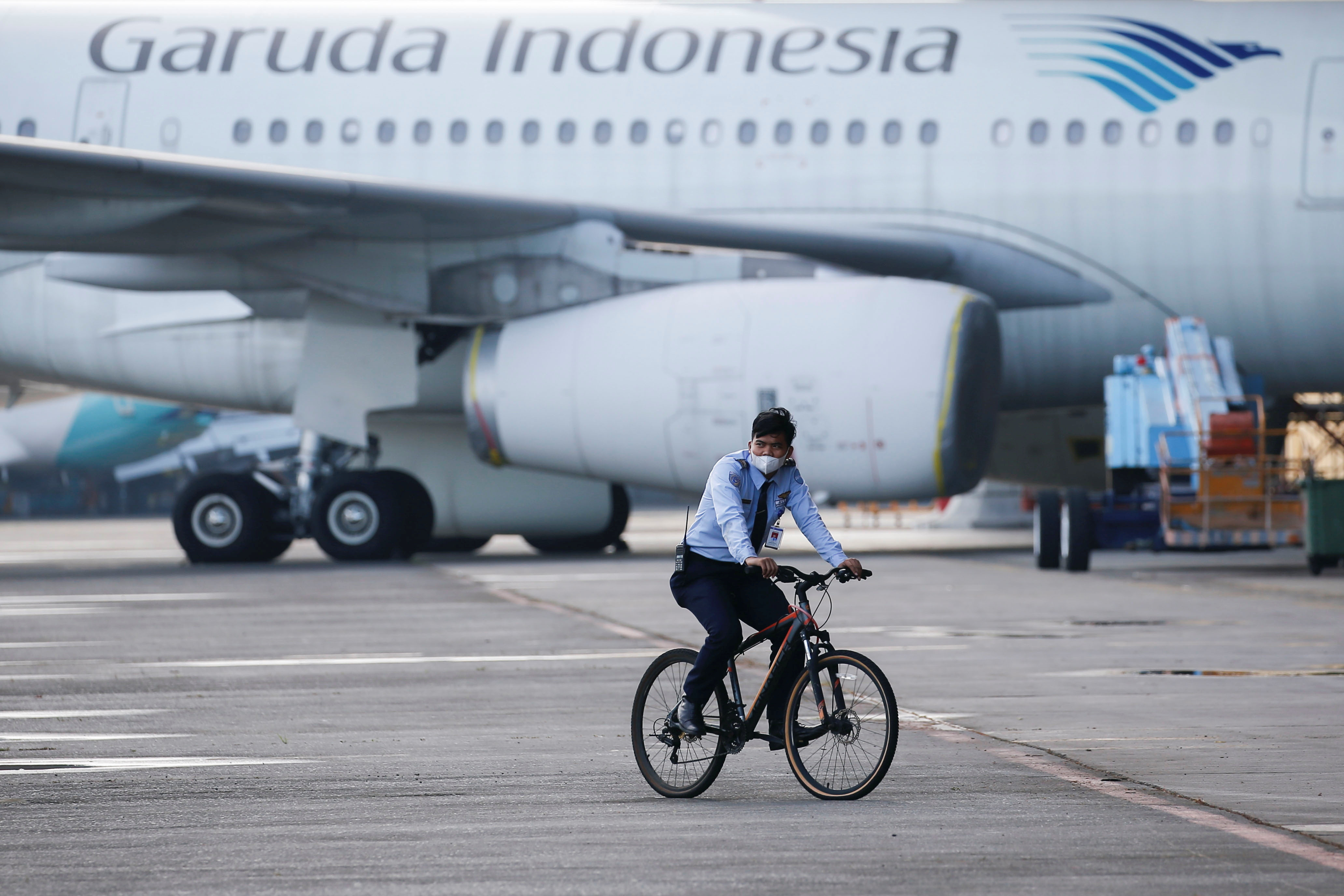An aviation security officer patrols at the GMF AeroAsia, near Jakarta