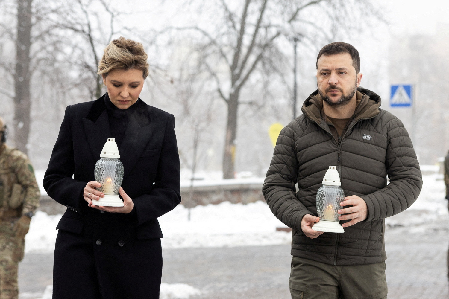 Ukraine's President Volodymyr Zelenskiy and his wife Olena attend a commemoration ceremony at a monument to the so-called 