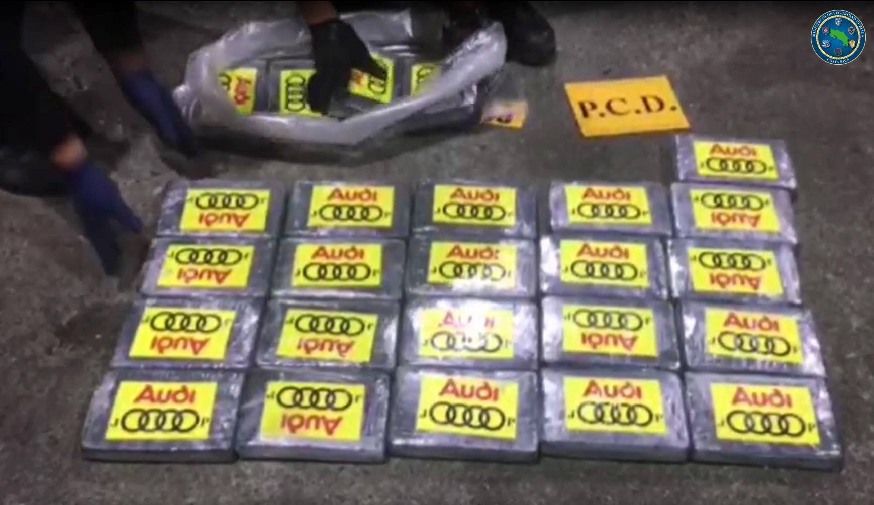 Police officers place packages containing cocaine seized during an operation of the Drug Control Police where 4.3 tones of cocaine was found hidden inside containers transported on a ship from Colombia, in Limon