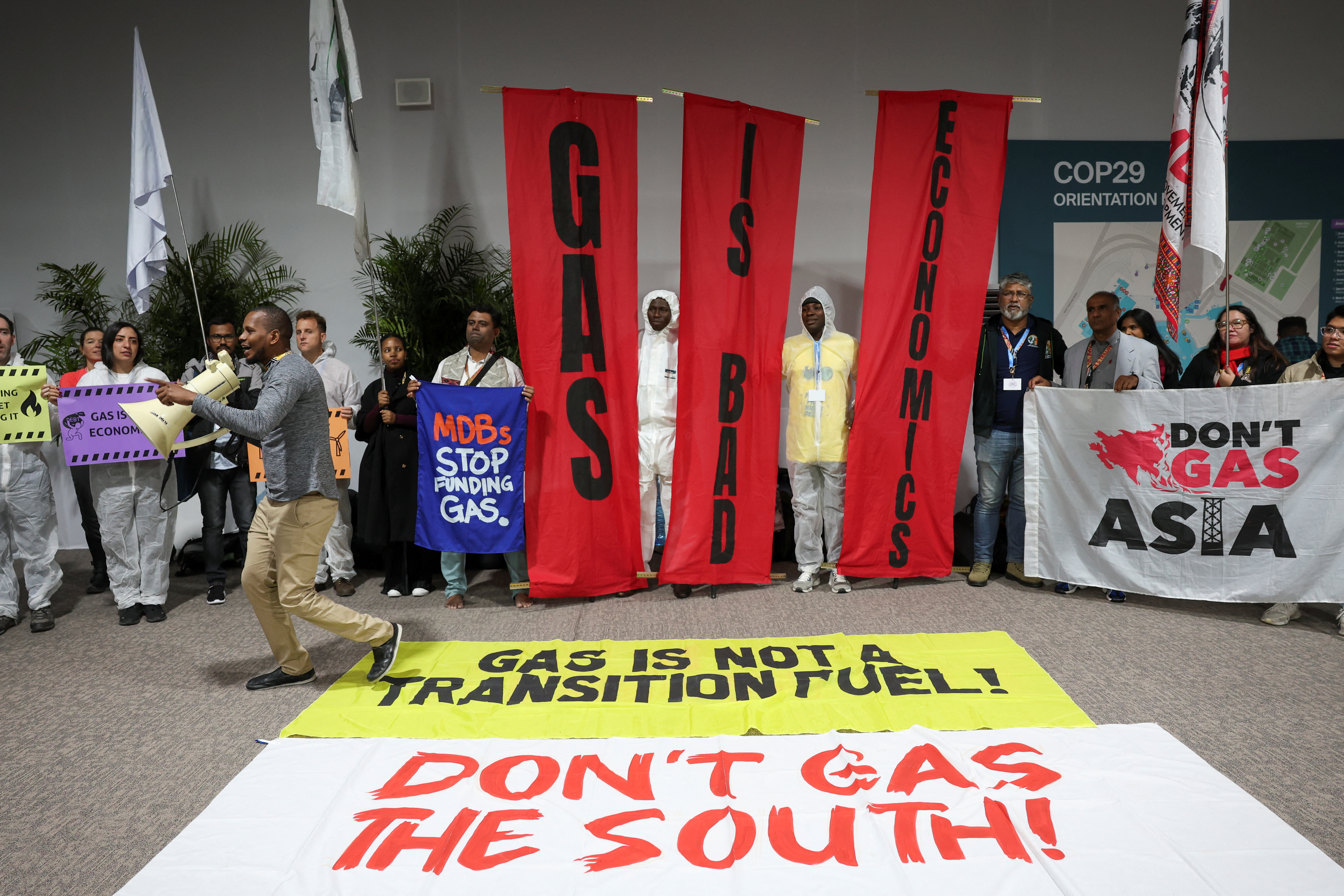 Activists protest against oil and gas lobbyists during COP29 in Baku