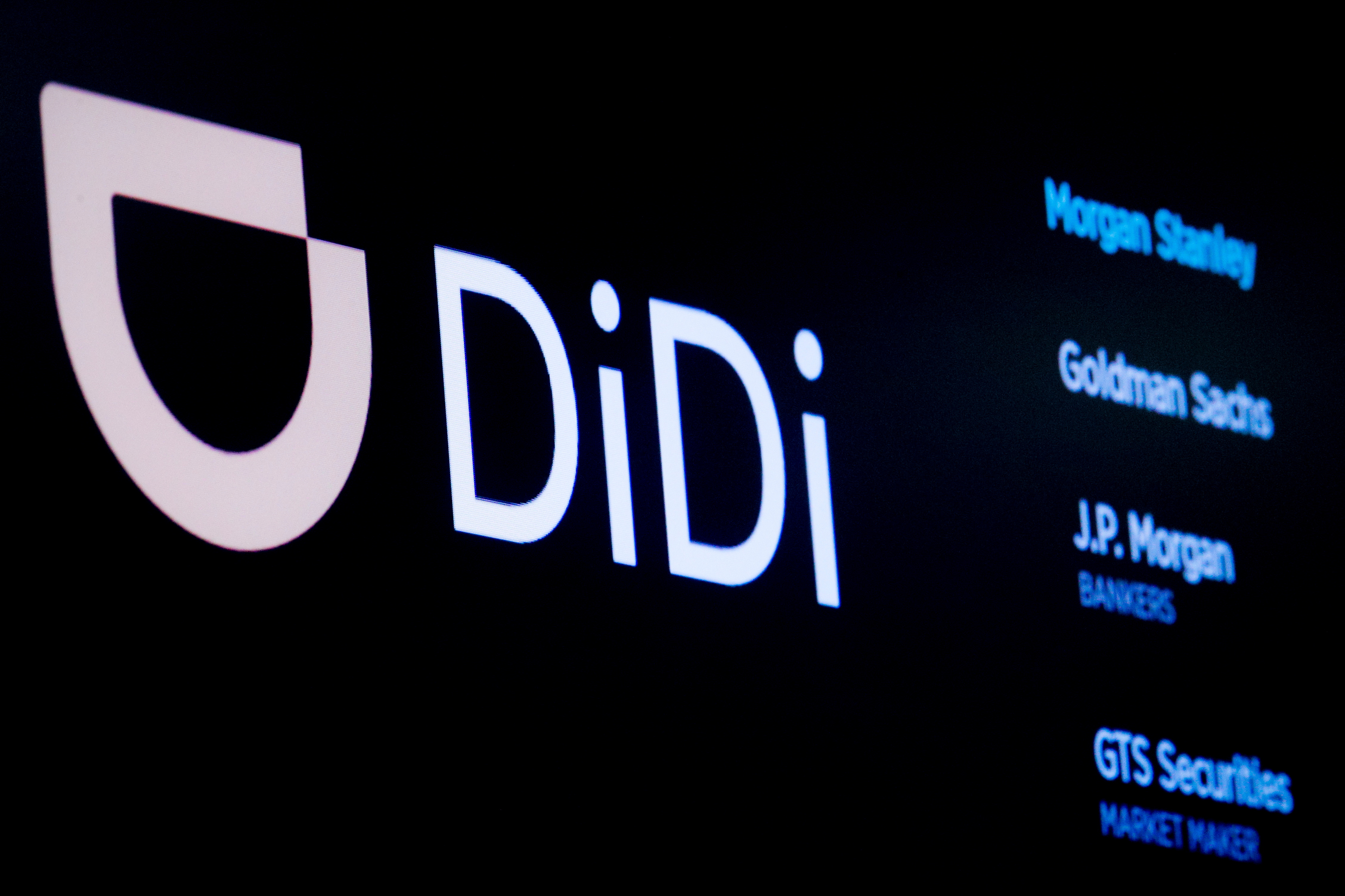 The logo for Chinese ride-hailing company Didi Global Inc is pictured at the New York Stock Exchange (NYSE) floor in New York City, U.S., June 30, 2021.  REUTERS/Brendan McDermid/File Photo