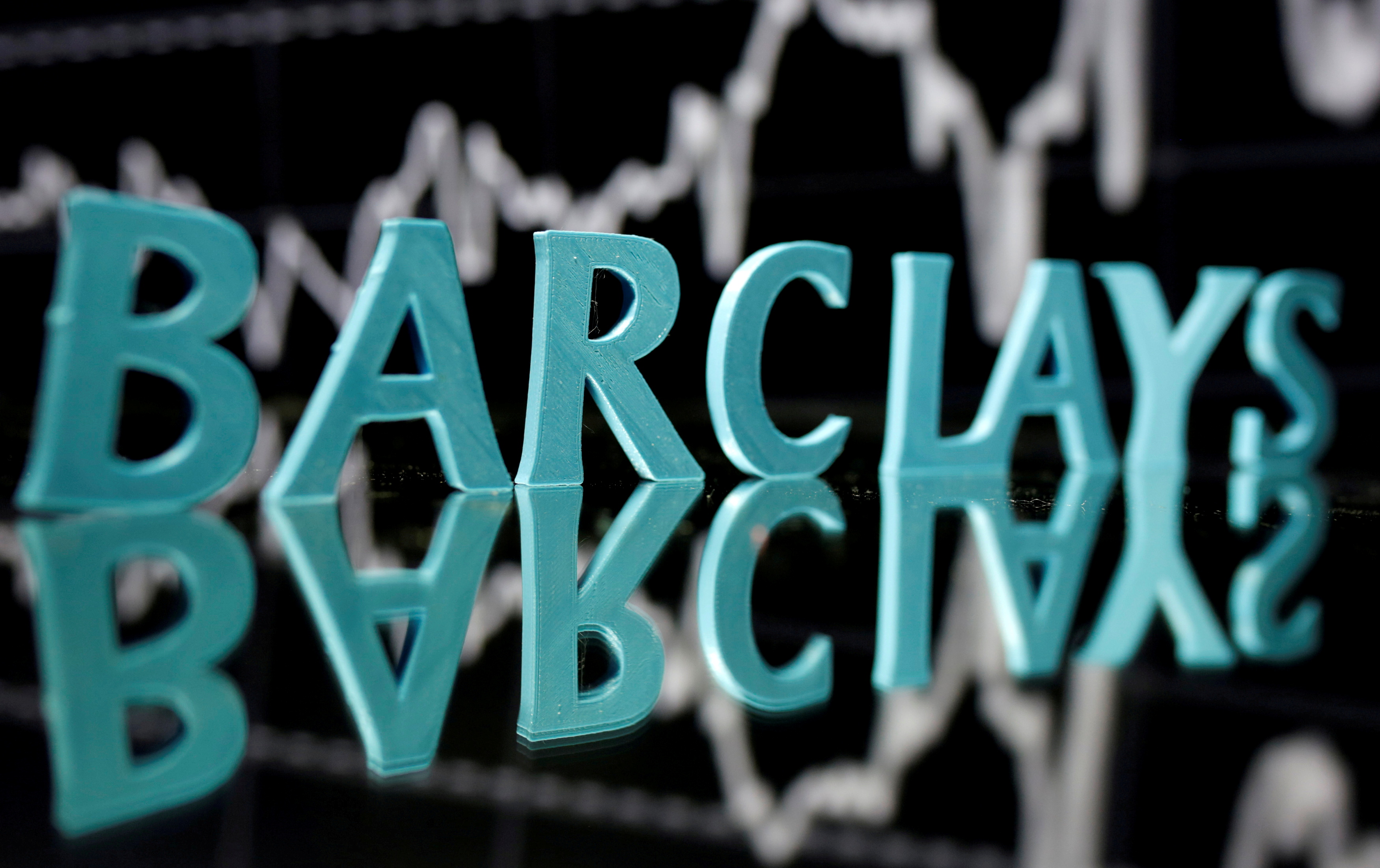 FILE PHOTO: The Barclays logo is seen in front of displayed stock graph in this illustration