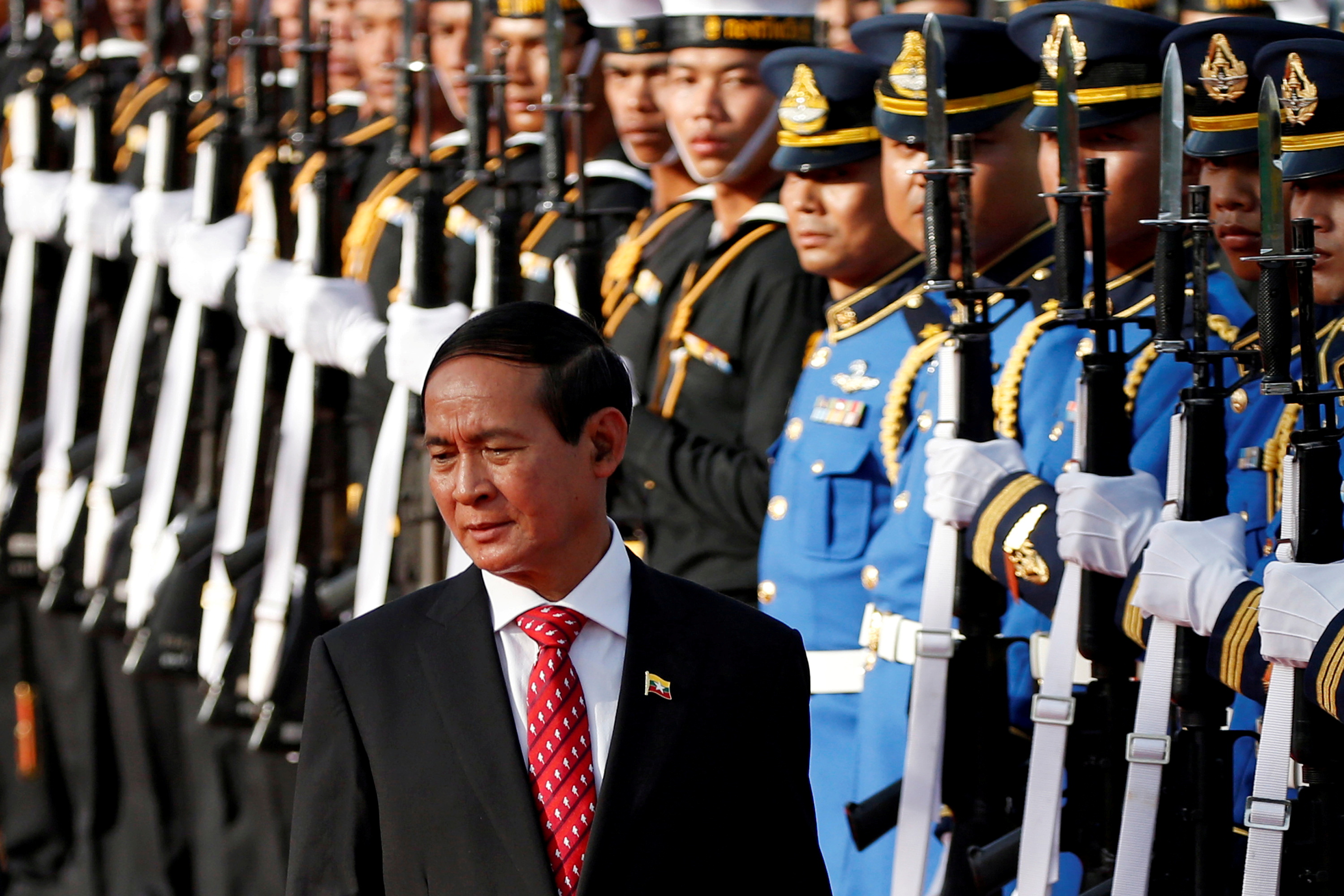 Myanmar's president Win Myint reviews the honor guard during his welcome ceremony at the Government House in Bangkok