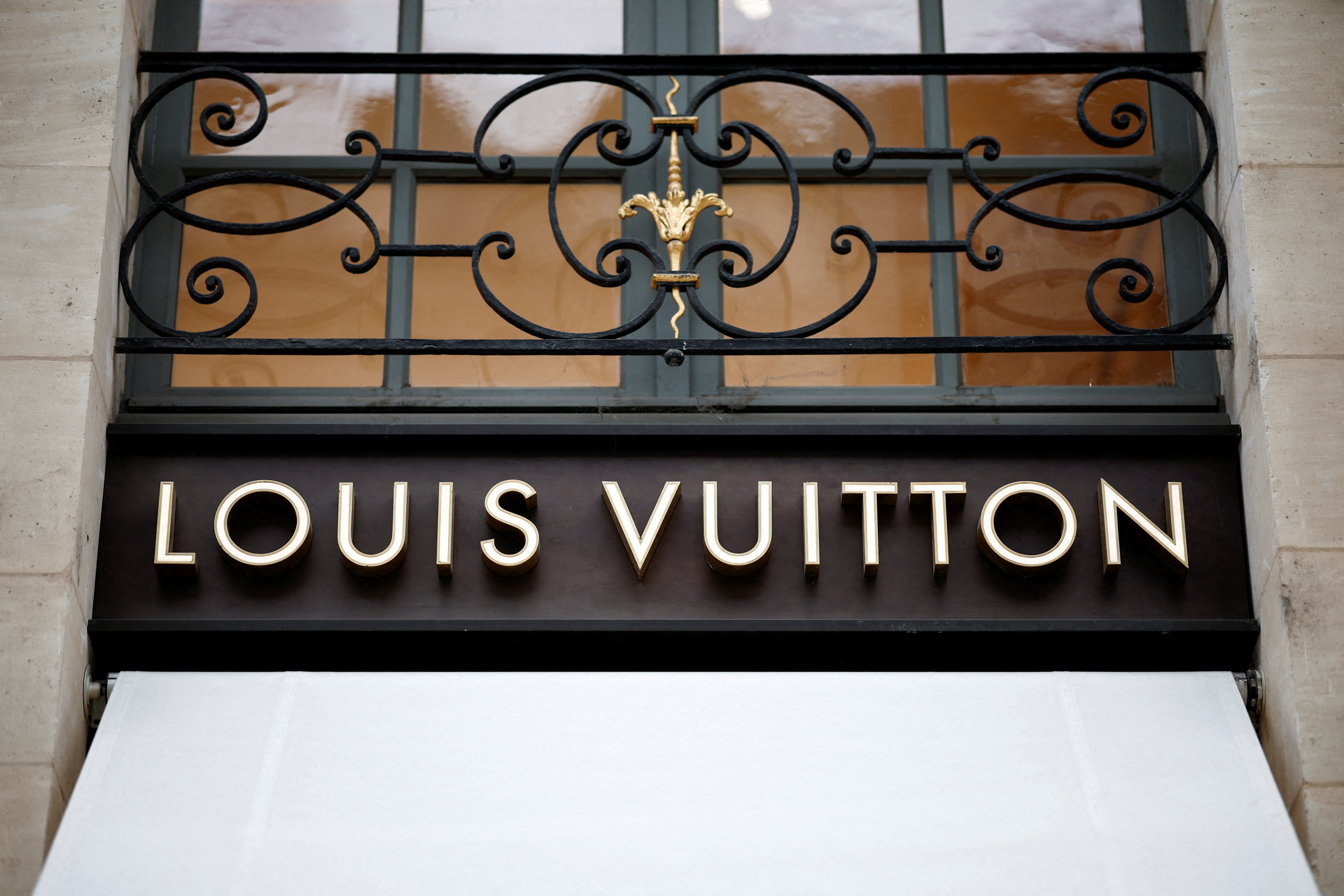 A sign on the exterior of a Louis Vuitton luxury boutique operated by LVMH Moet Hennessy Louis SE is pictured in Paris