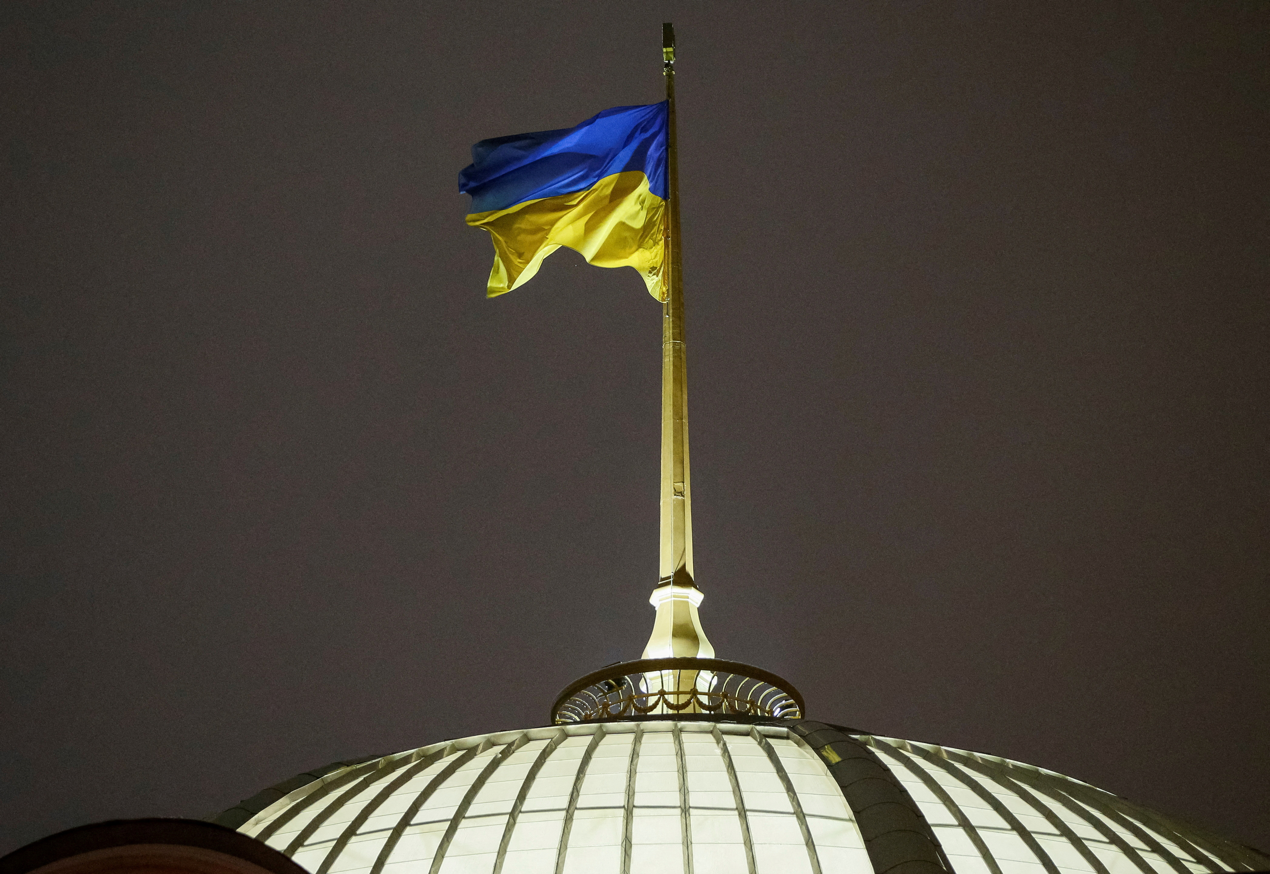 A Ukrainian national flag flies over the parliament building in Kyiv