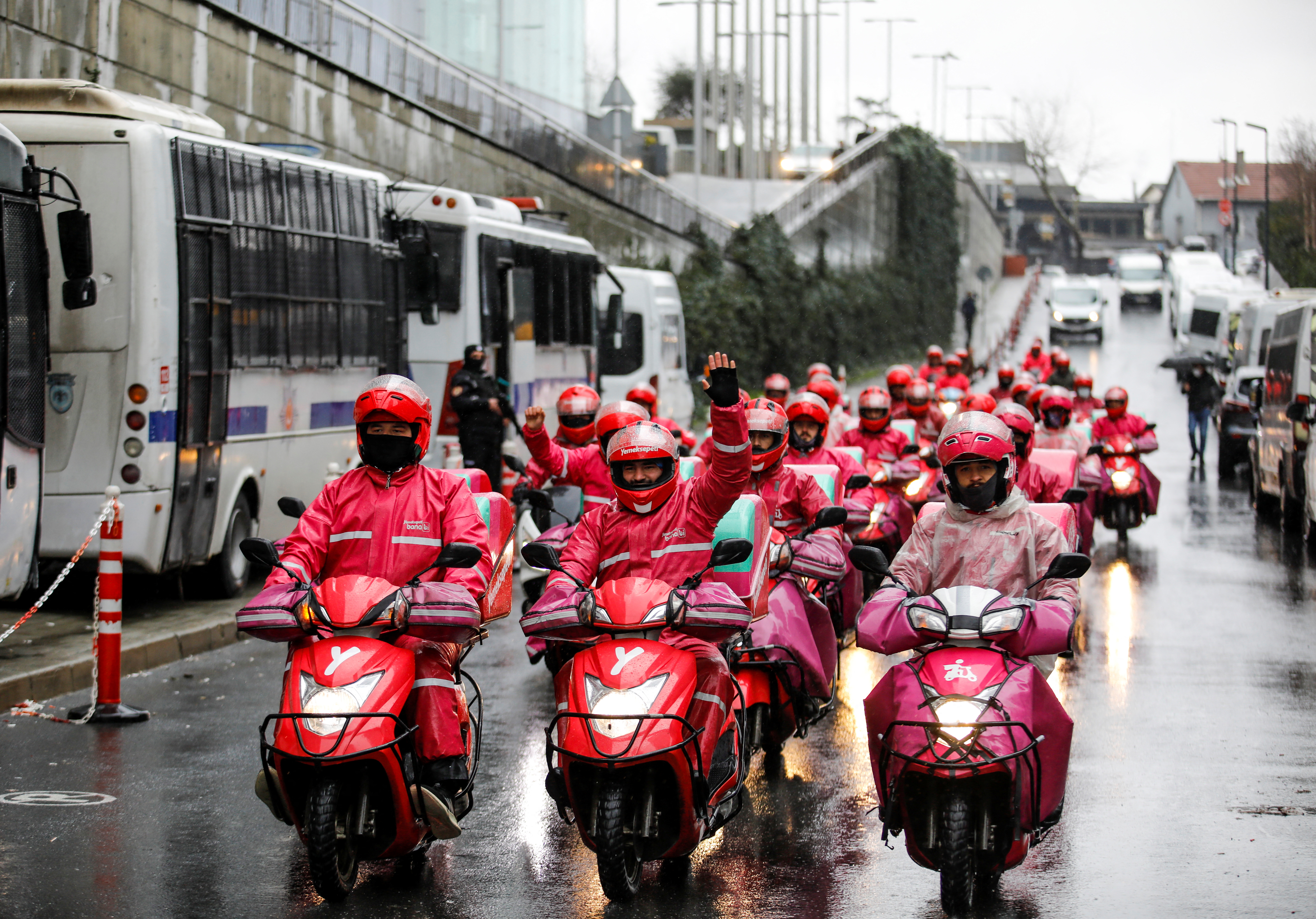 Delivery couriers of Yemek Sepeti on strike shout slogans on their scooters in Istanbul