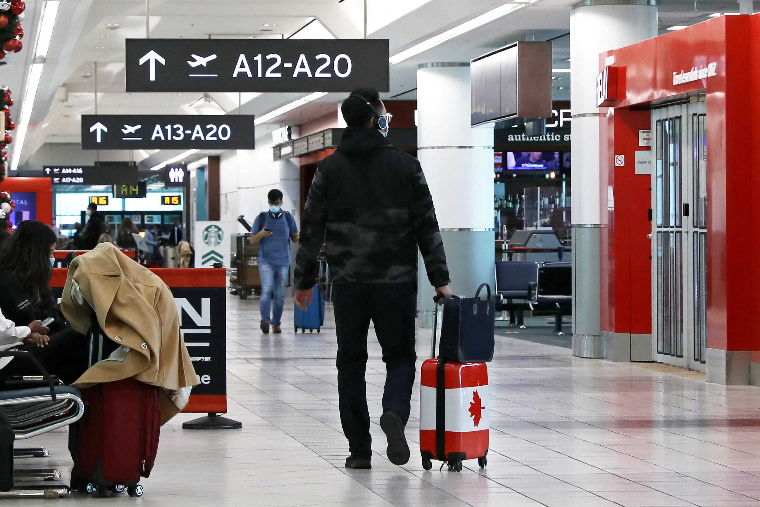 A United States-bound passenger walks in Toronto Pearson Airport's Terminal 3, days before new coronavirus disease (COVID-19) testing protocols to enter the U.S. come into effect, in Toronto, Ontario, Canada December 3, 2021. REUTERS/Chris Helgren