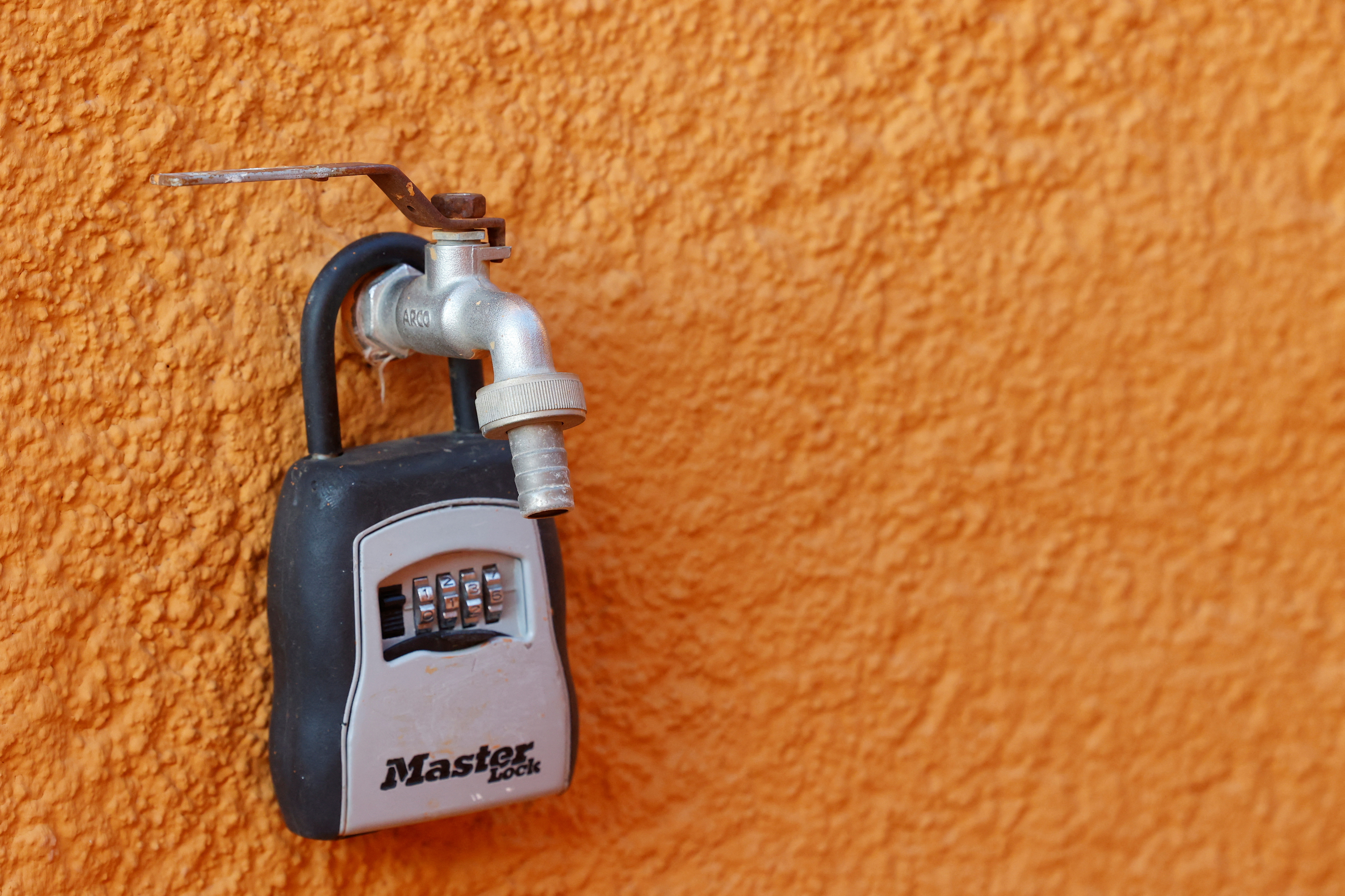 A padlock from a tourist apartment is hooked on a tap in a municipality with water restrictions in Javea