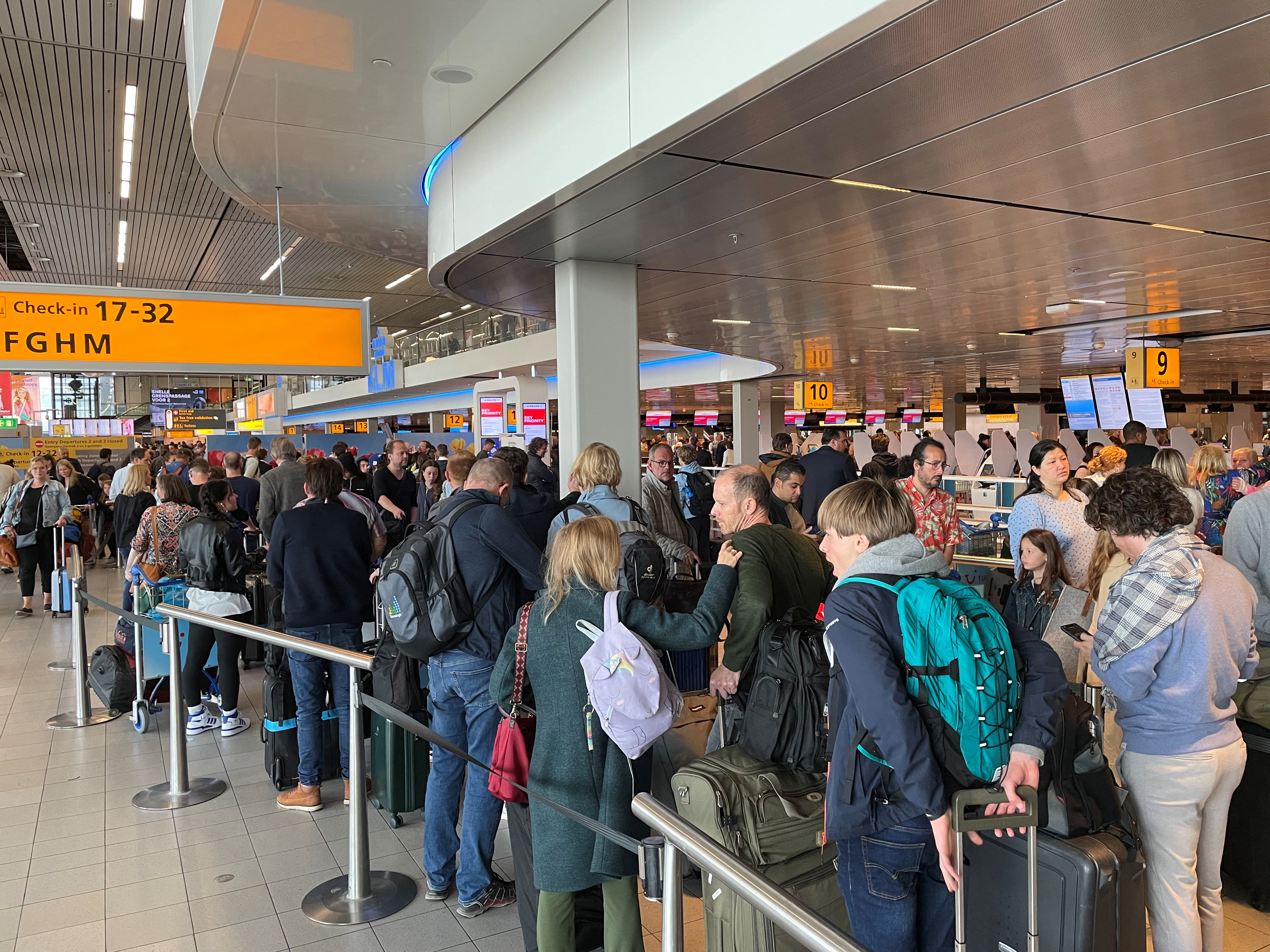 Long lines of waiting travellers at Amsterdam Schiphol Airport due to unannounced strike
