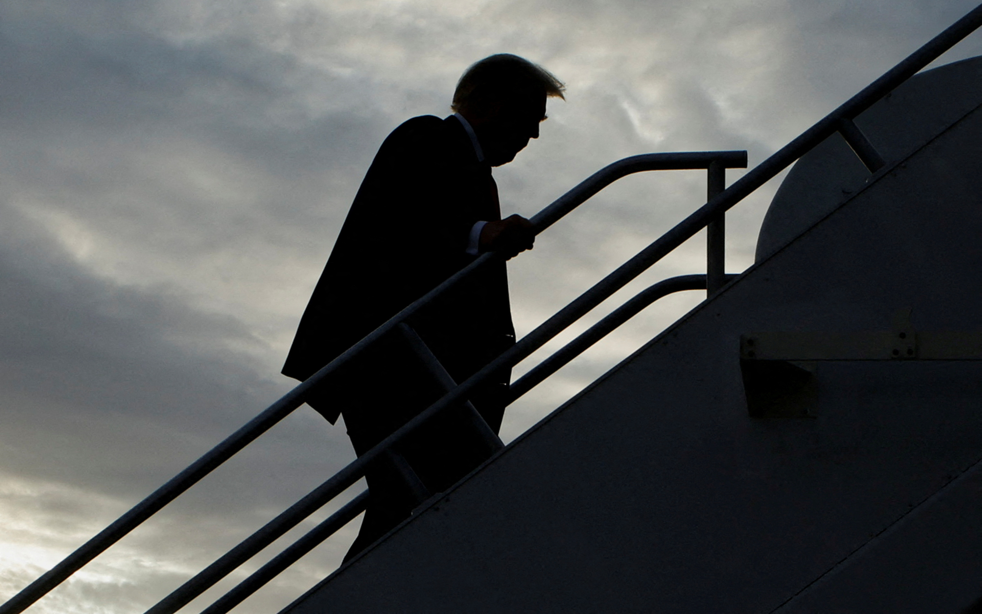 Former U.S. President and Republican presidential candidate Donald Trump boards his plane to depart from Eastern Iowa Airport