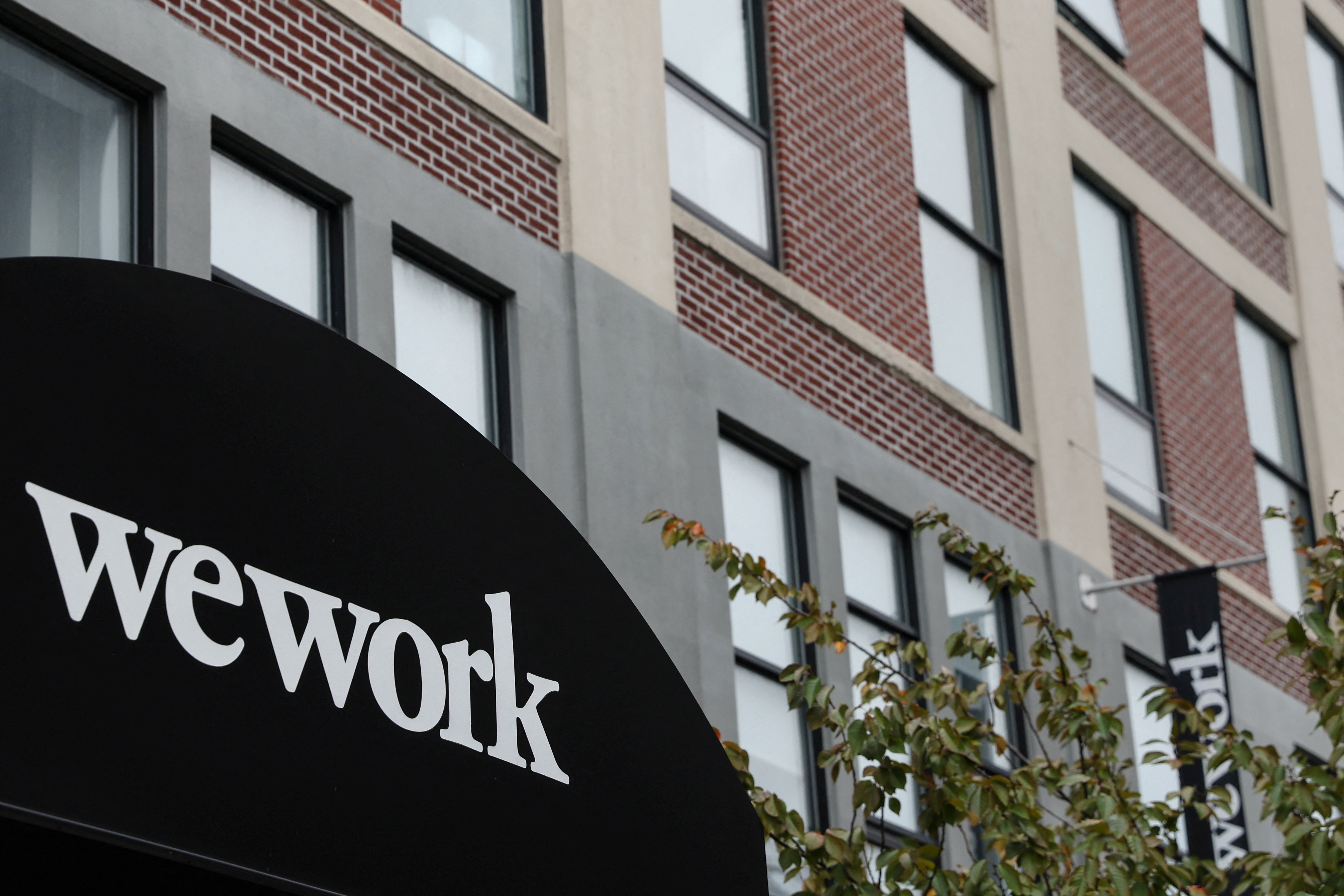 A WeWork logo is seen outside its offices in the Queens borough of New York City