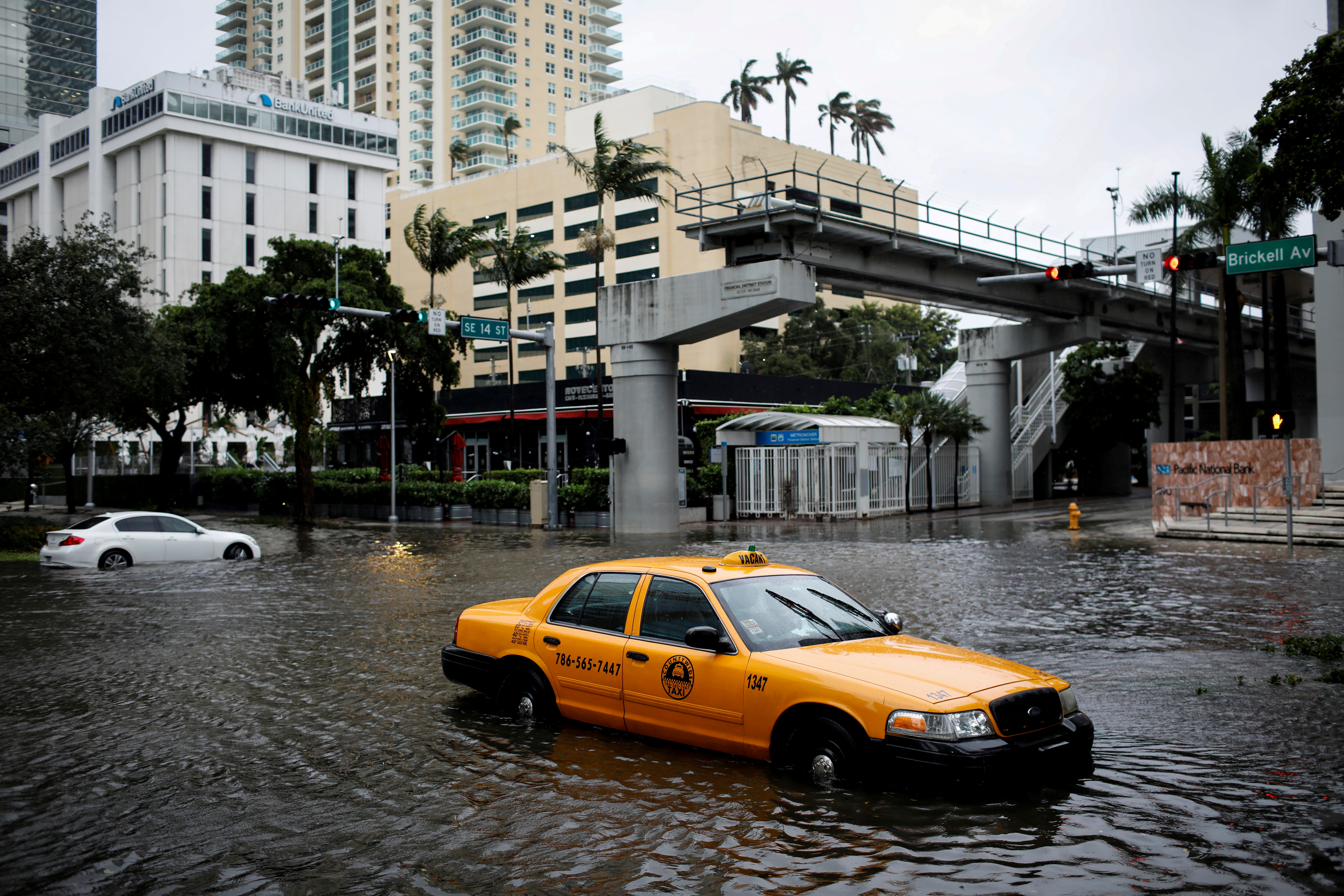 A damaged taxi is seen in floodwaters caused by Tropical Storm Eta in a street at the Brickell neighborhood in Miami