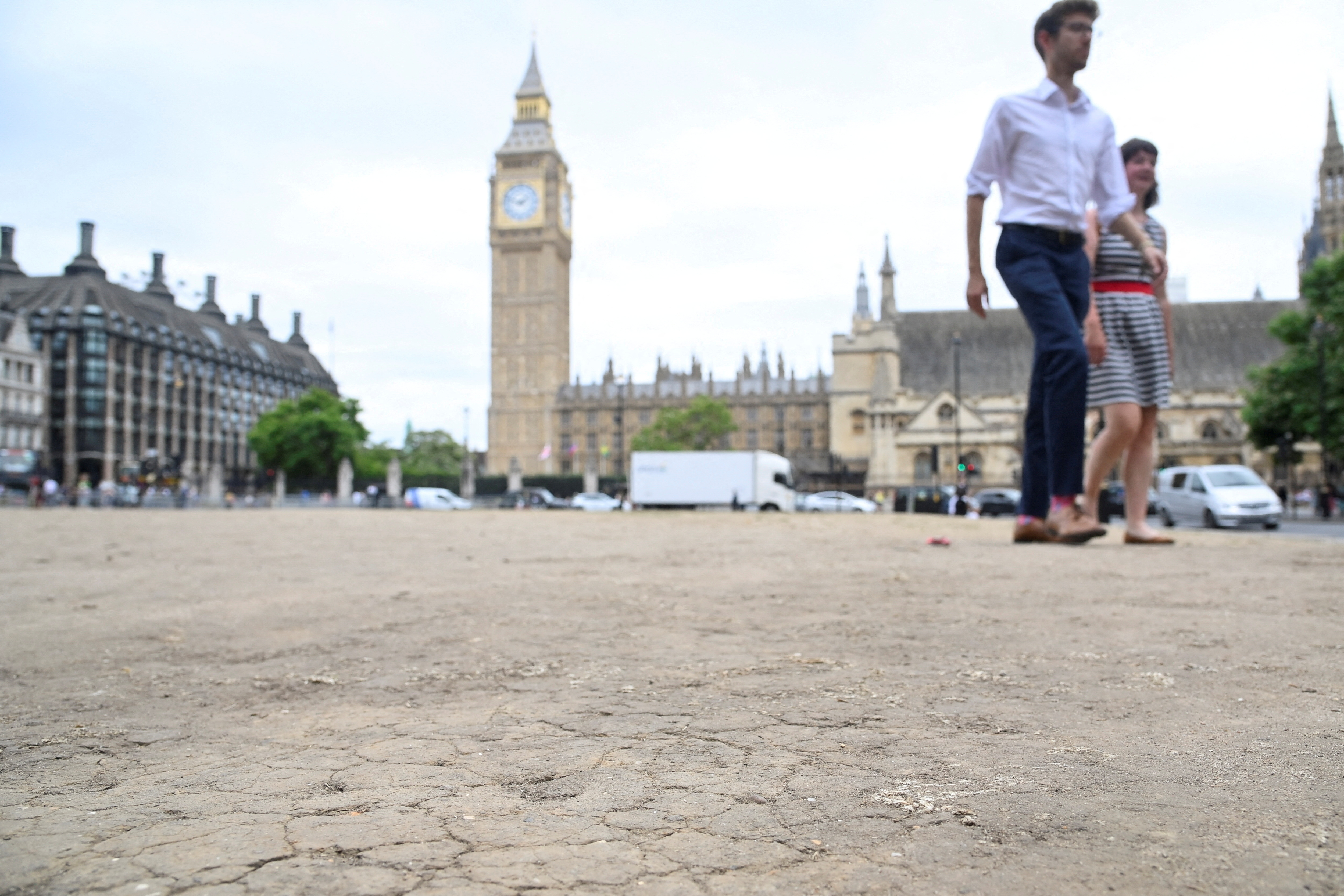 Cracked earth is seen as hot weather continues, in Parliament Square, London