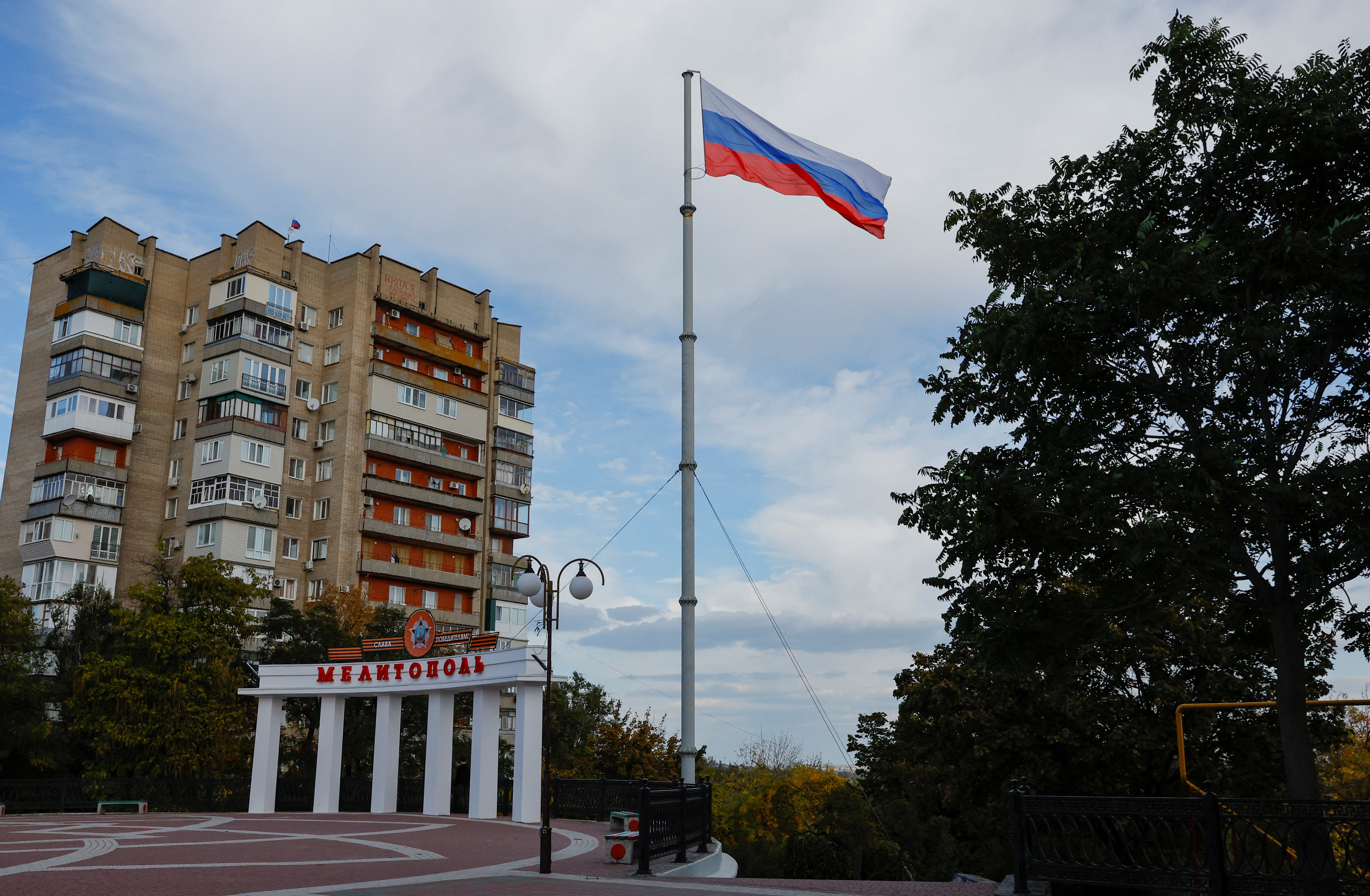 A Russian flag flies in a square in Melitopol