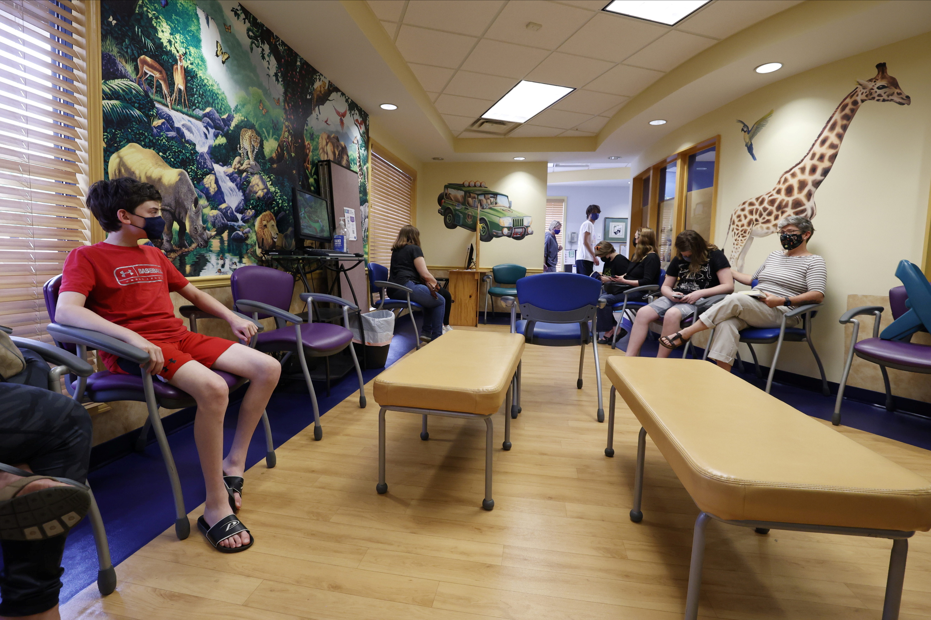 Aidan Mohl, 13,  joins others in a waiting room after receiving Pfizer's vaccine against coronavirus disease (COVID-19), after Georgia authorized the vaccine for ages over 12 years, at Dekalb Pediatric Center in Decatur