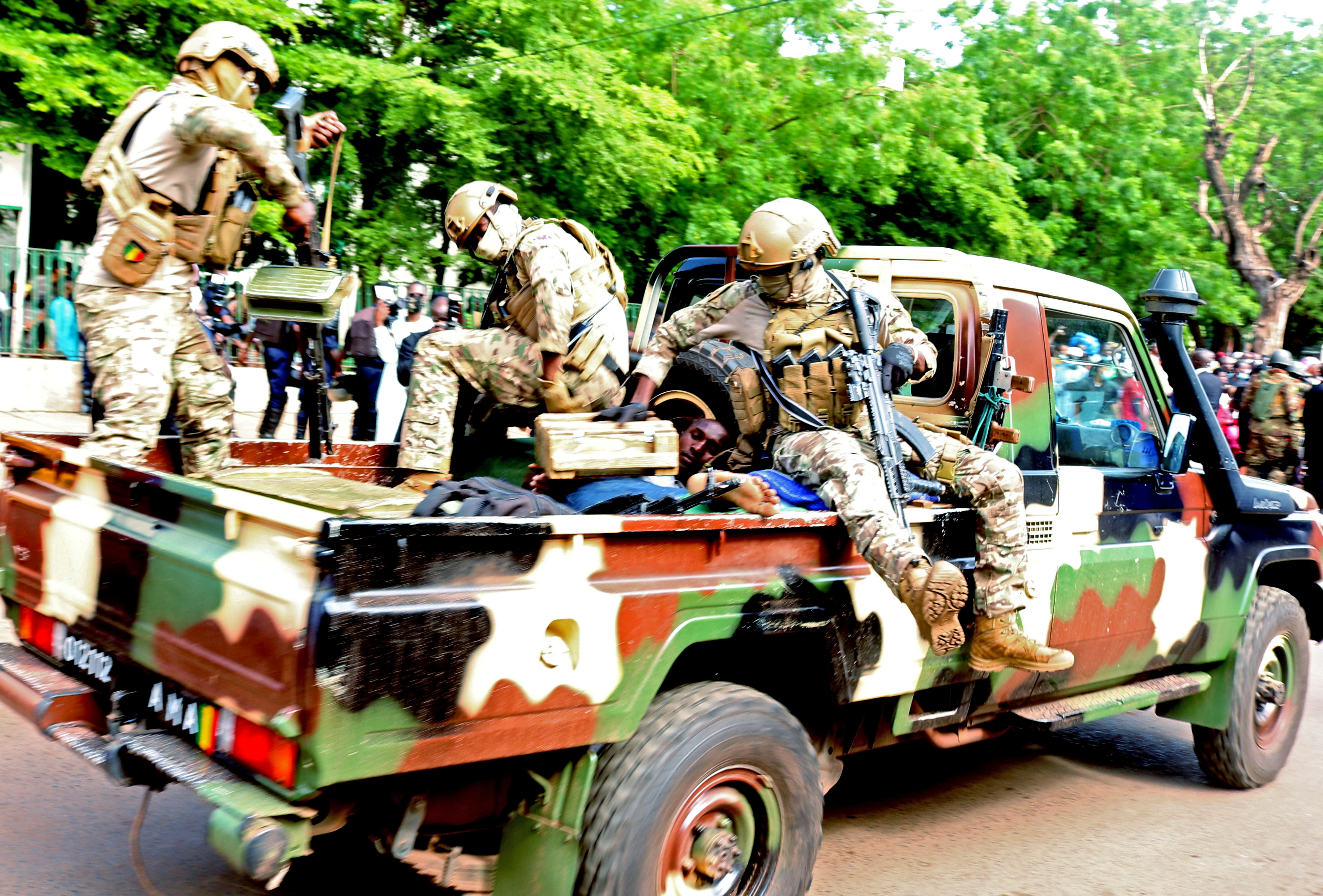 An assailant who attempted to stab Mali's interim president Colonel Assimi Goita, is seen lying in an army vehicle after he was arrested in Bamako