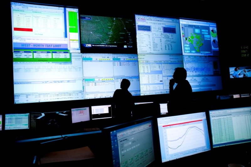 FILE PHOTO: Reliability Coordinators monitor the state power grid during a tour of the Electric Reliability Council of Texas (ERCOT) command center in Taylor