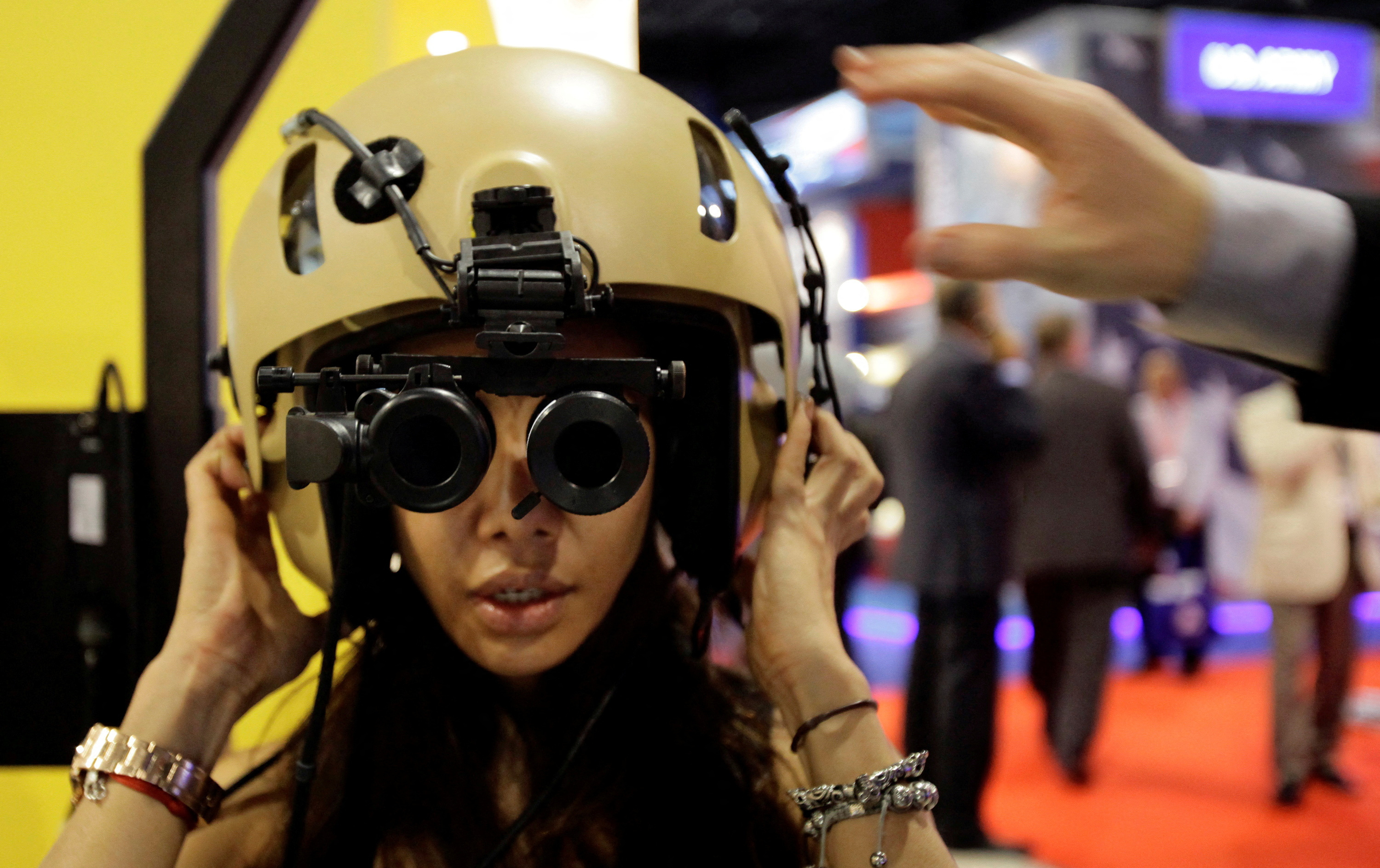 A visitor tries on an ANVIS/HUD at the Elbit Systems booth at the Singapore Airshow in Singapore