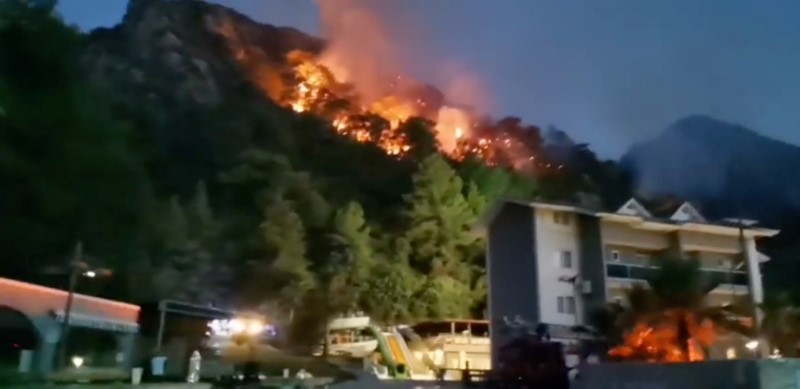 Vegetation fires burn behind the hotel in Icmeler, near Marmaris