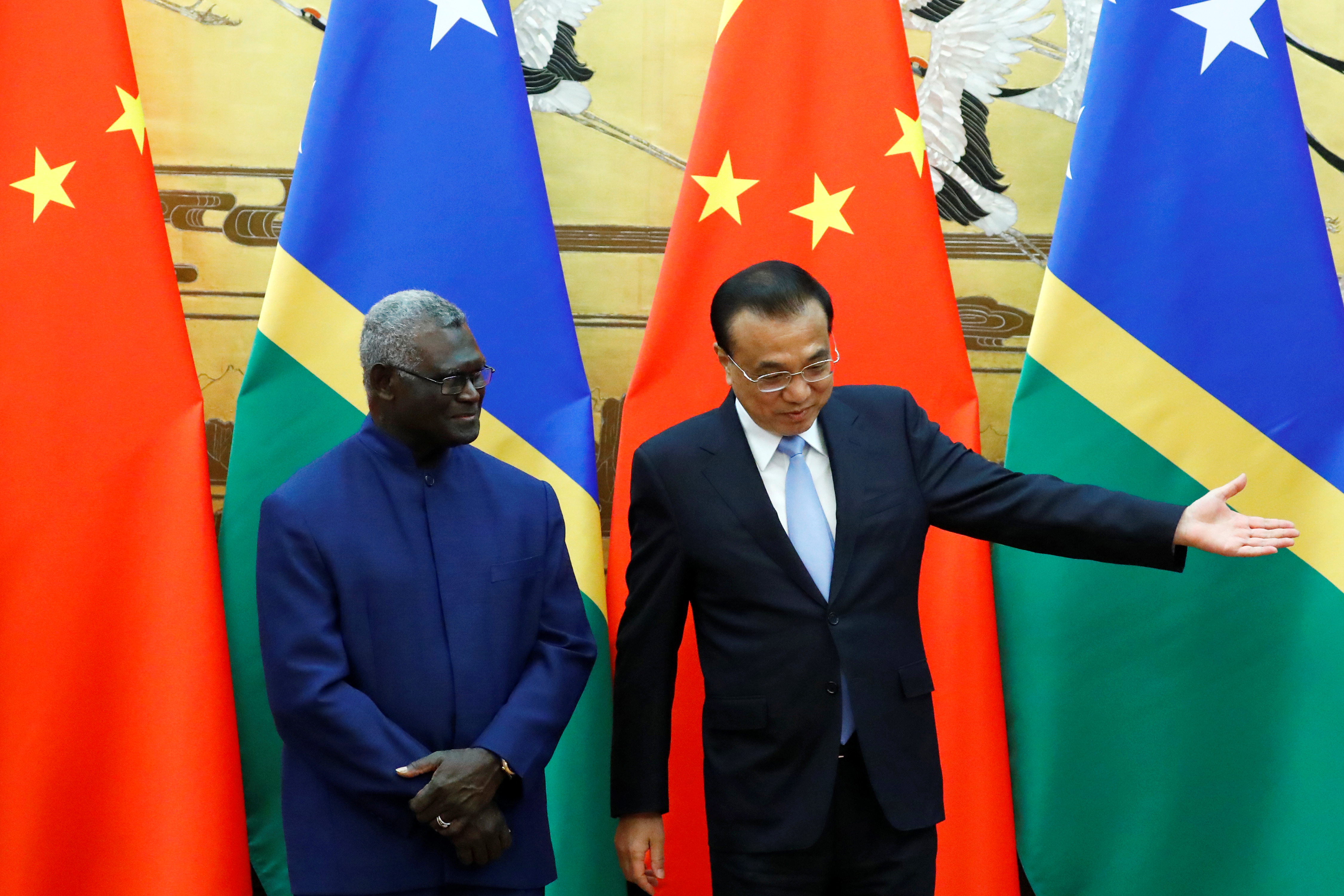 Solomon Islands Prime Minister Manasseh Sogavare and Chinese Premier Li Keqiang attend a signing ceremony at the Great Hall of the People in Beijing
