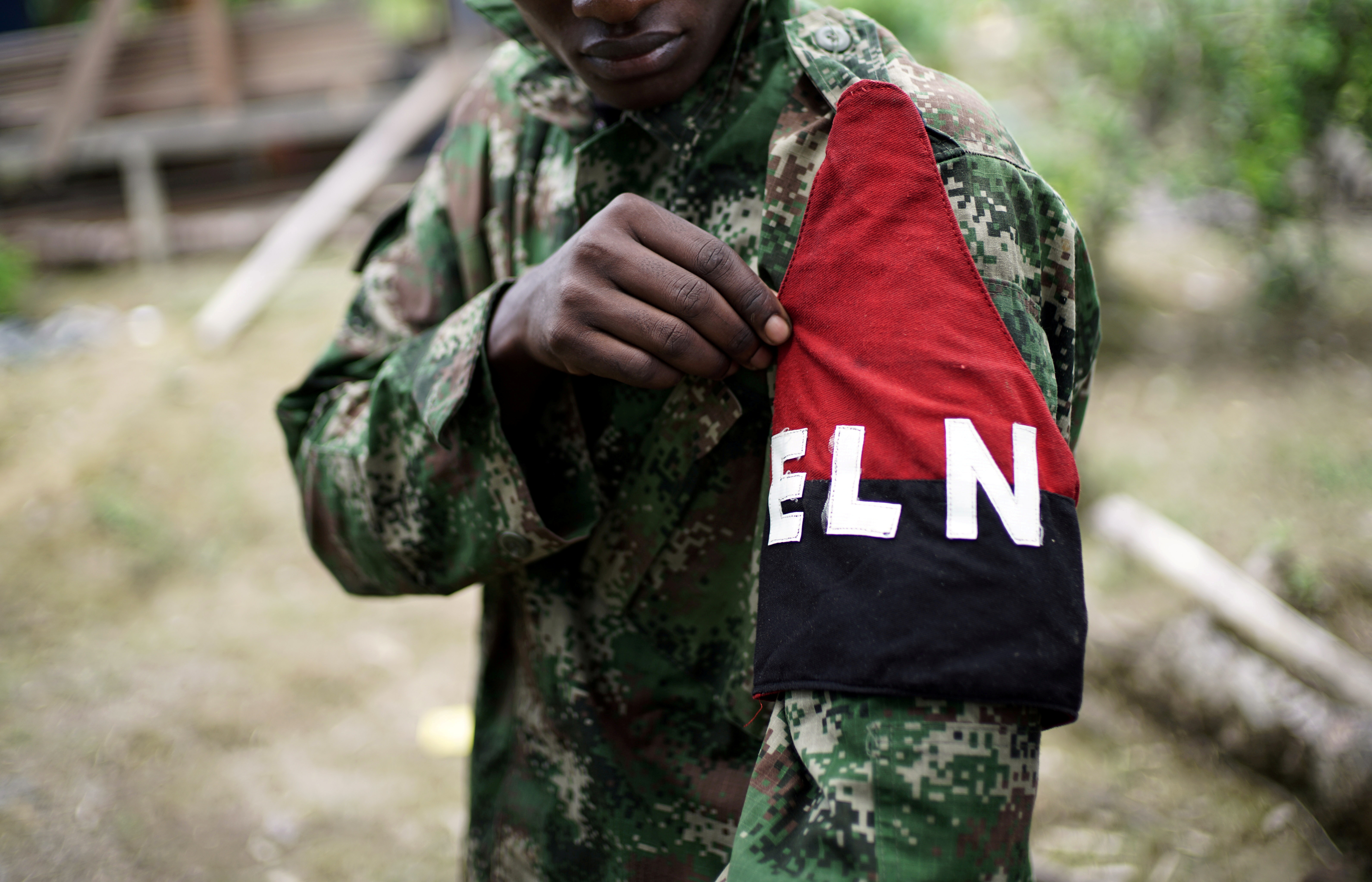 A rebel of Colombia's Marxist National Liberation Army shows his armband while posing for a photograph, in the northwestern jungles