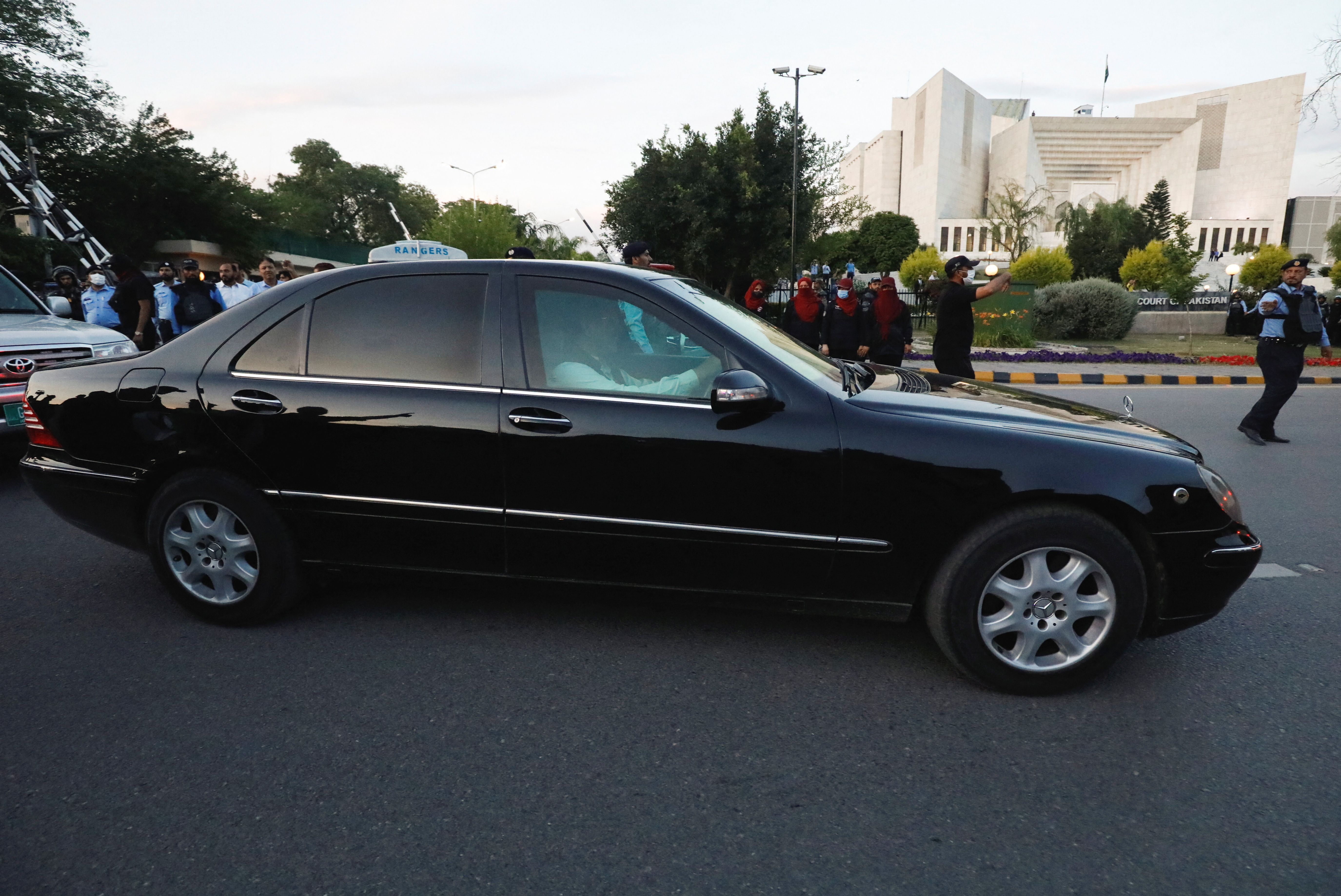 A vehicle carries Pakistan's former Prime Minister Imran Khan, as he leaves the Supreme Court building in Islamabad