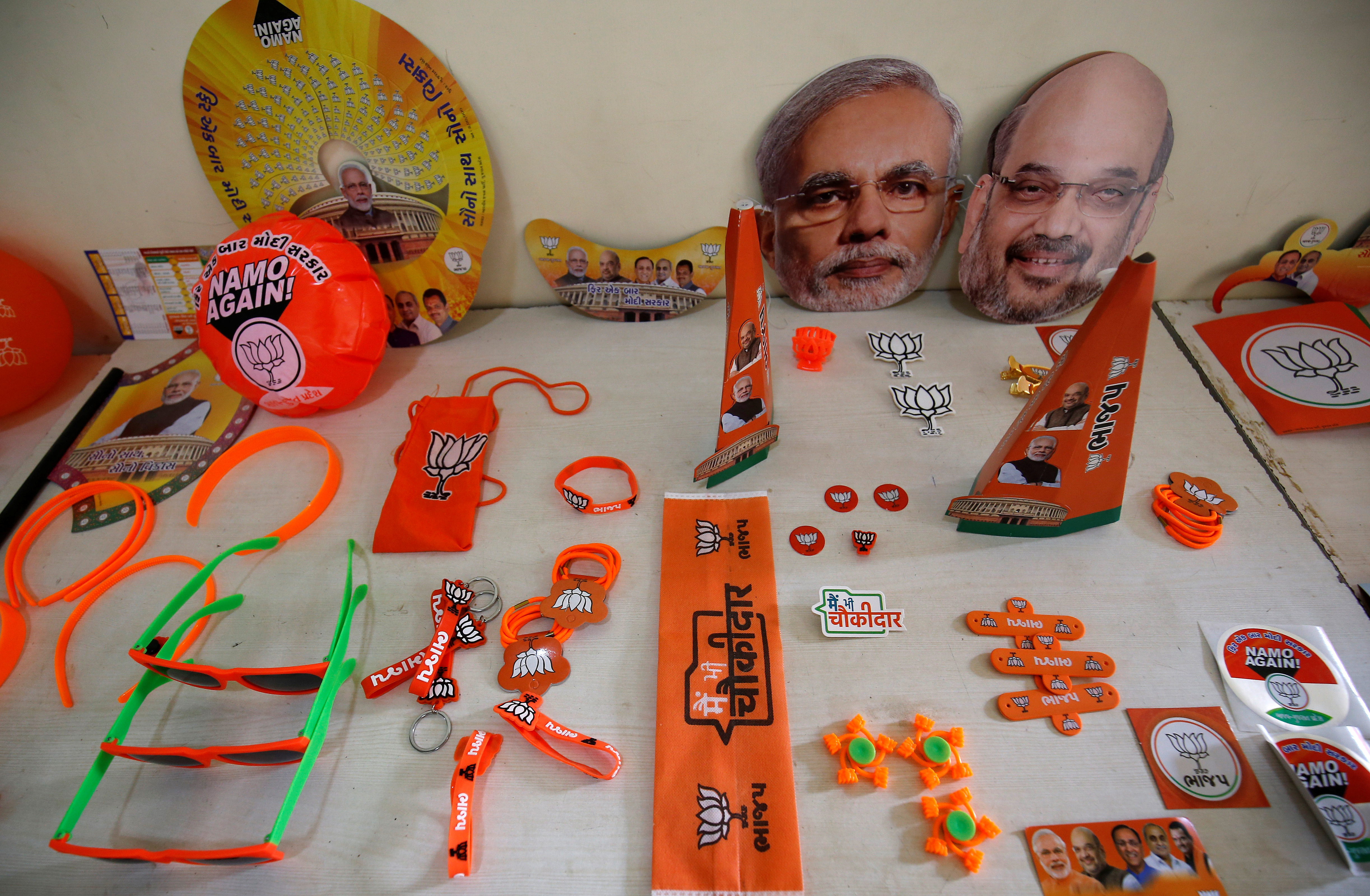 Wristbands, key chains and badges featuring India's ruling BJP and masks of the party president Shah and PM Modi are on display inside a BJP office ahead of general election, in Gandhinagar