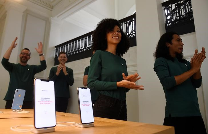 Apple store employees cheer during the grand opening and media preview of the new Apple Carnegie Library store in Washington