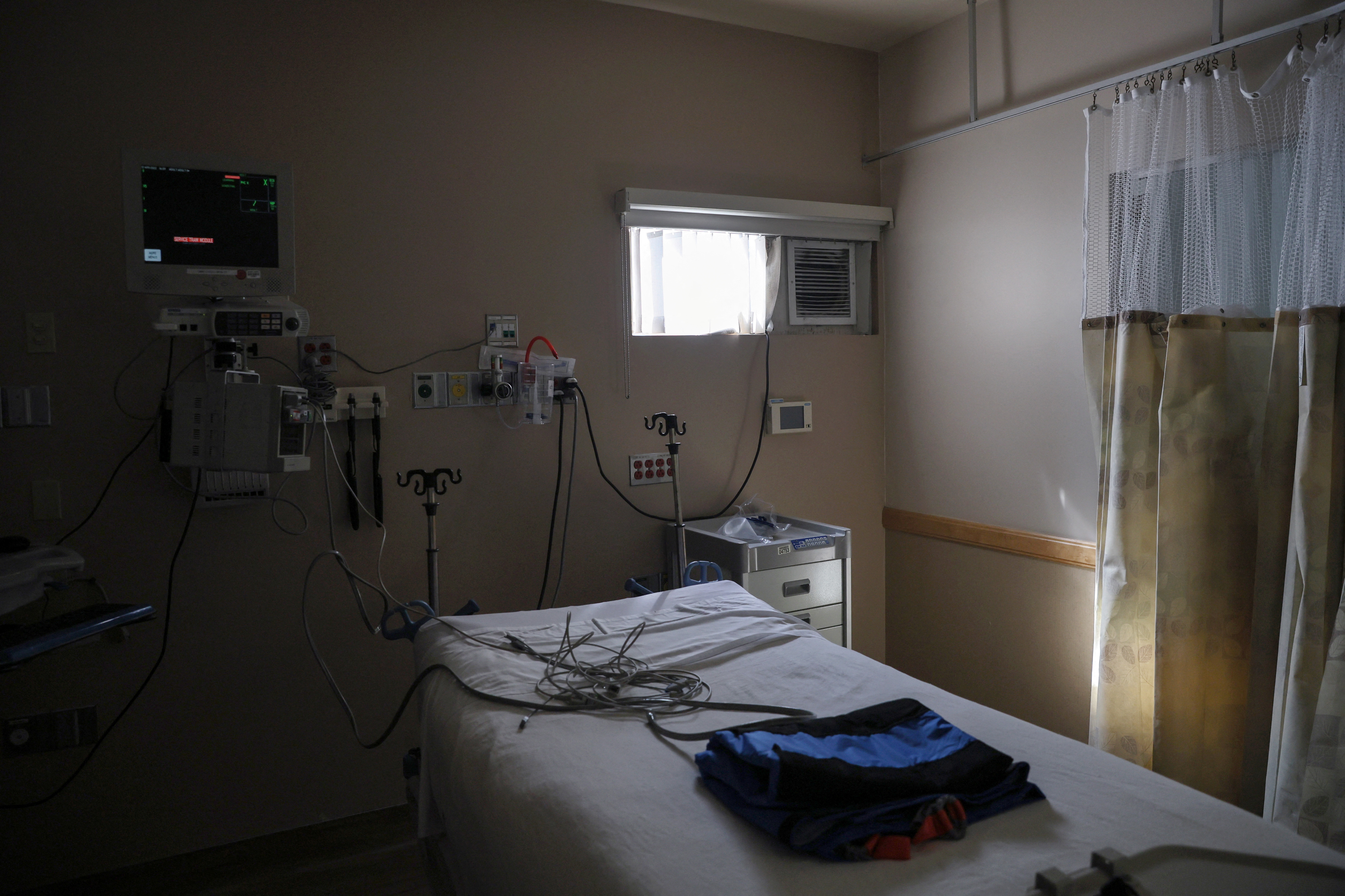 An empty hospital bed sits inside the former Intensive Care Unit for COVID-19 patients