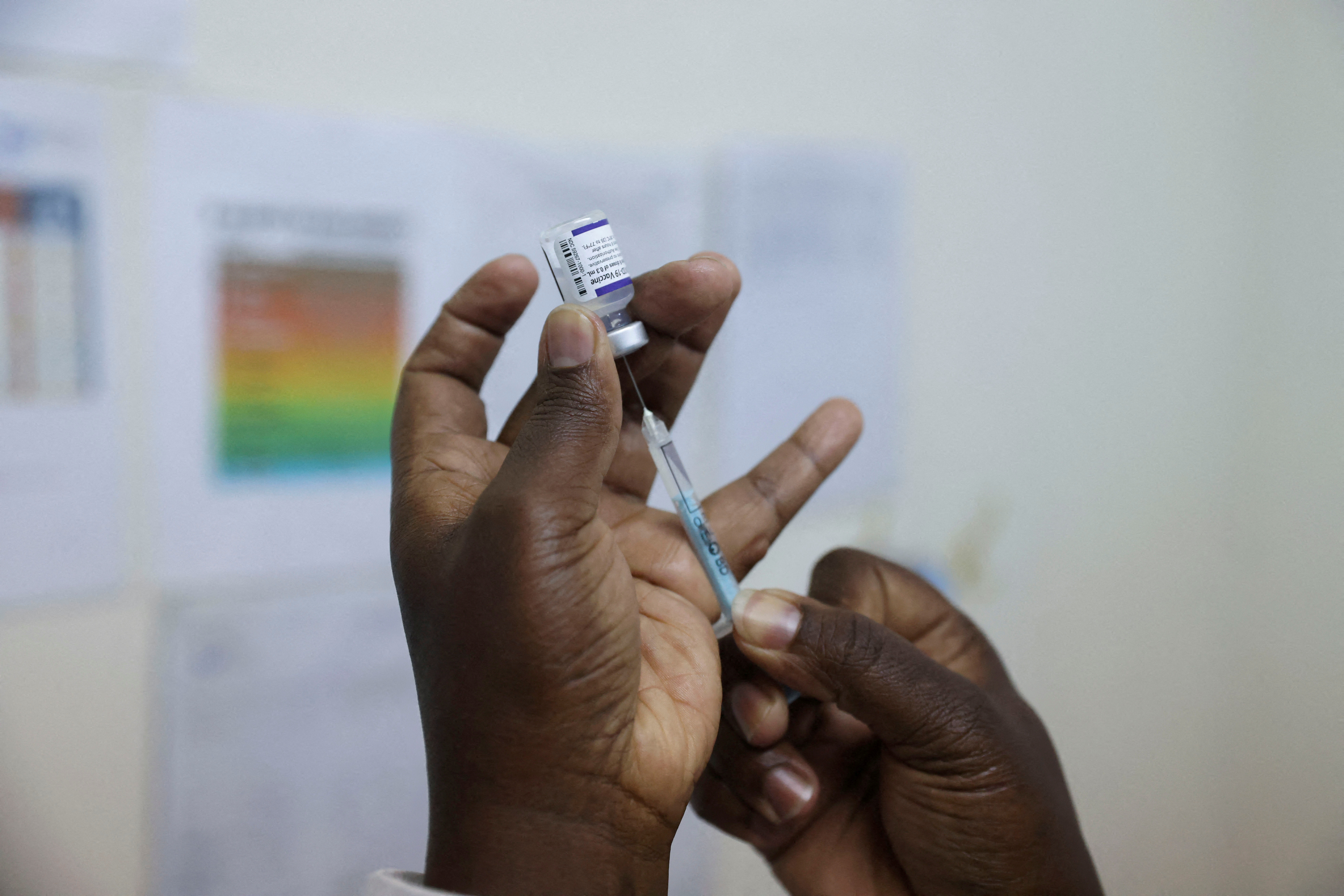 A health worker prepares a dose of Pfizer/BioNTech's COVID-19 vaccine, at the Penda health center in Nairobi