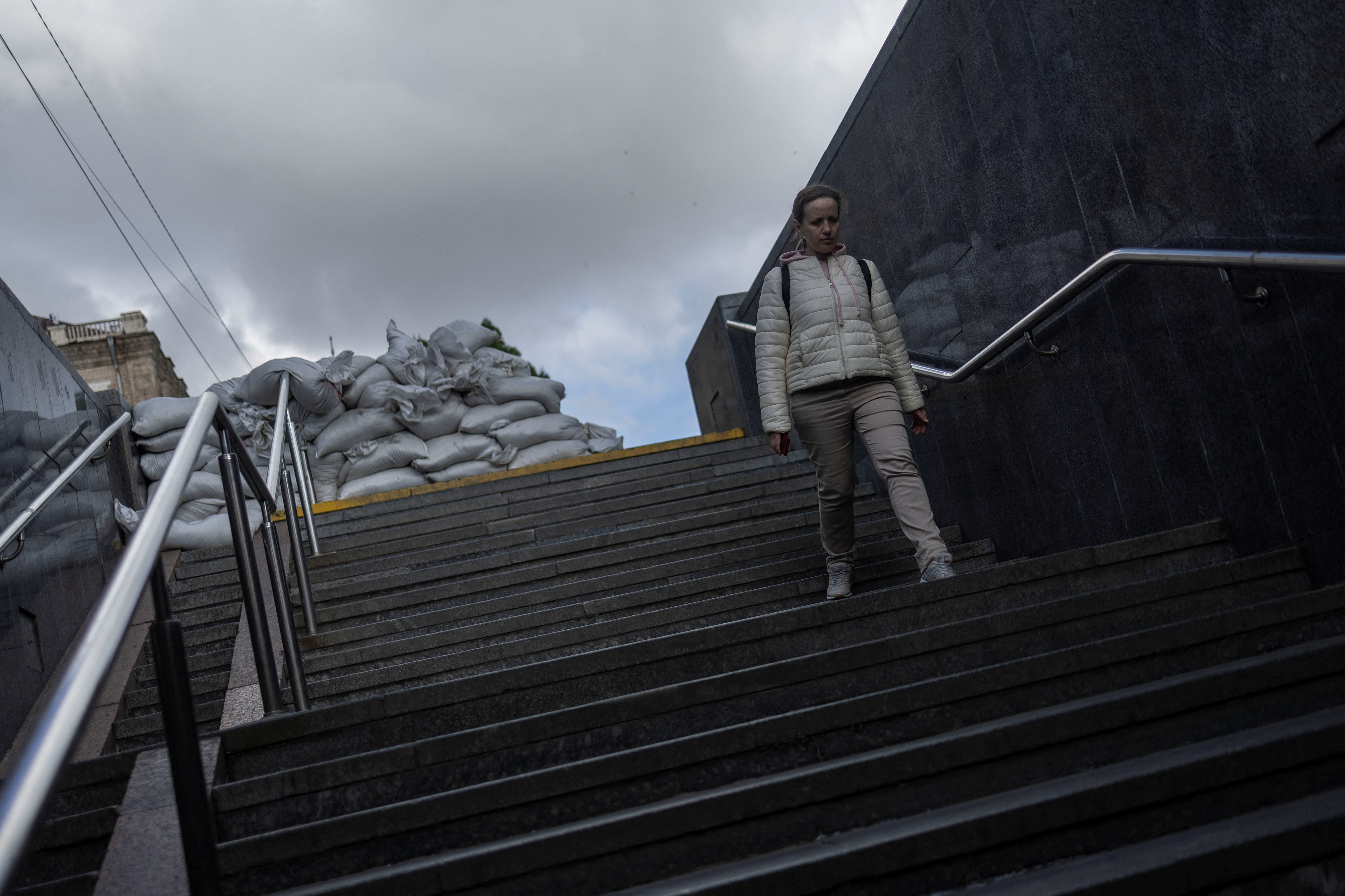 A woman walks into a metro station in downtown Kyiv, as Russia celebrates Victory Day, which marks the 77th anniversary of the victory over Nazi Germany in World War Two, in Kyiv
