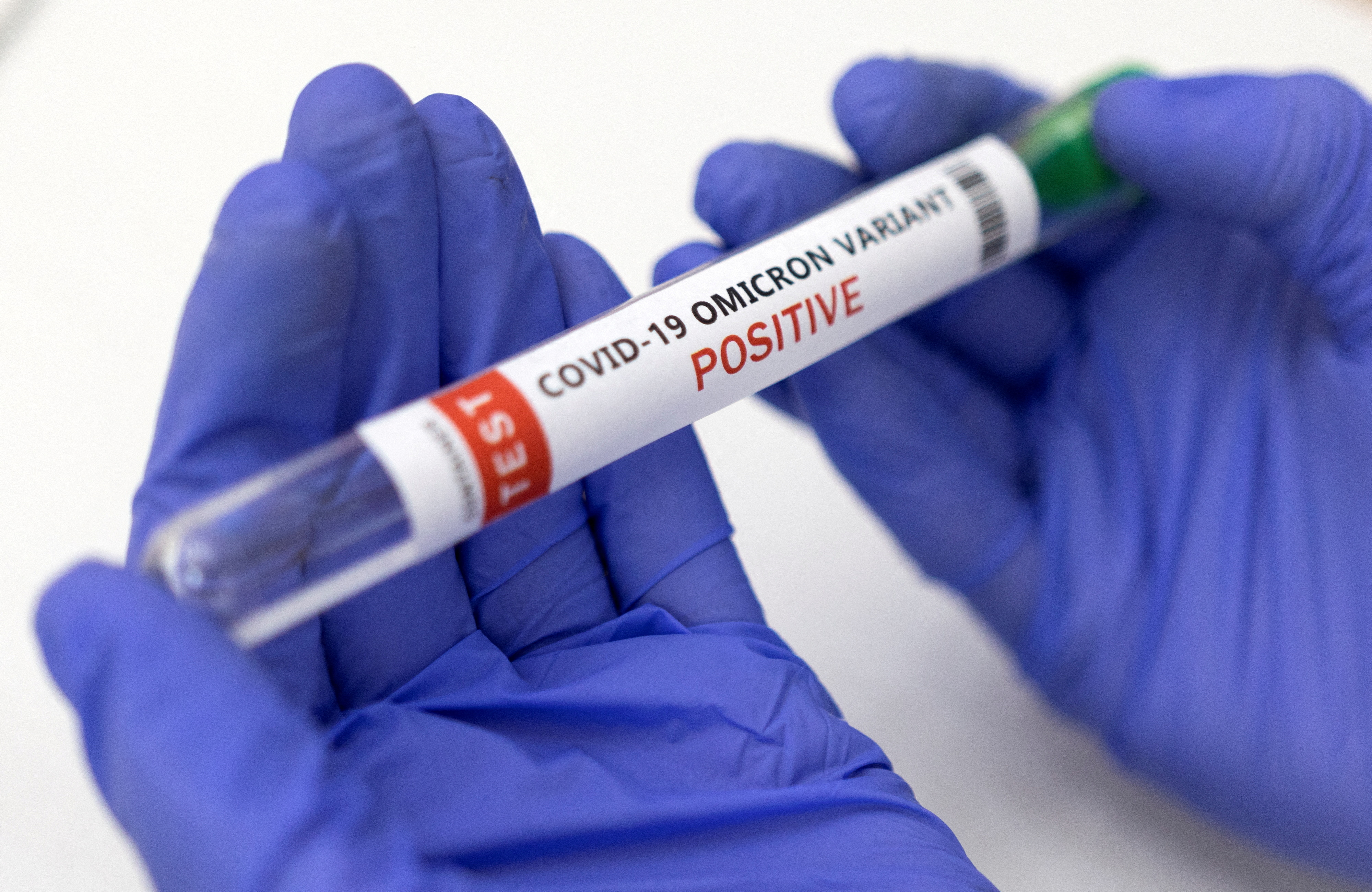 Illustration shows test tube labelled "COVID-19 Omicron variant test positive\