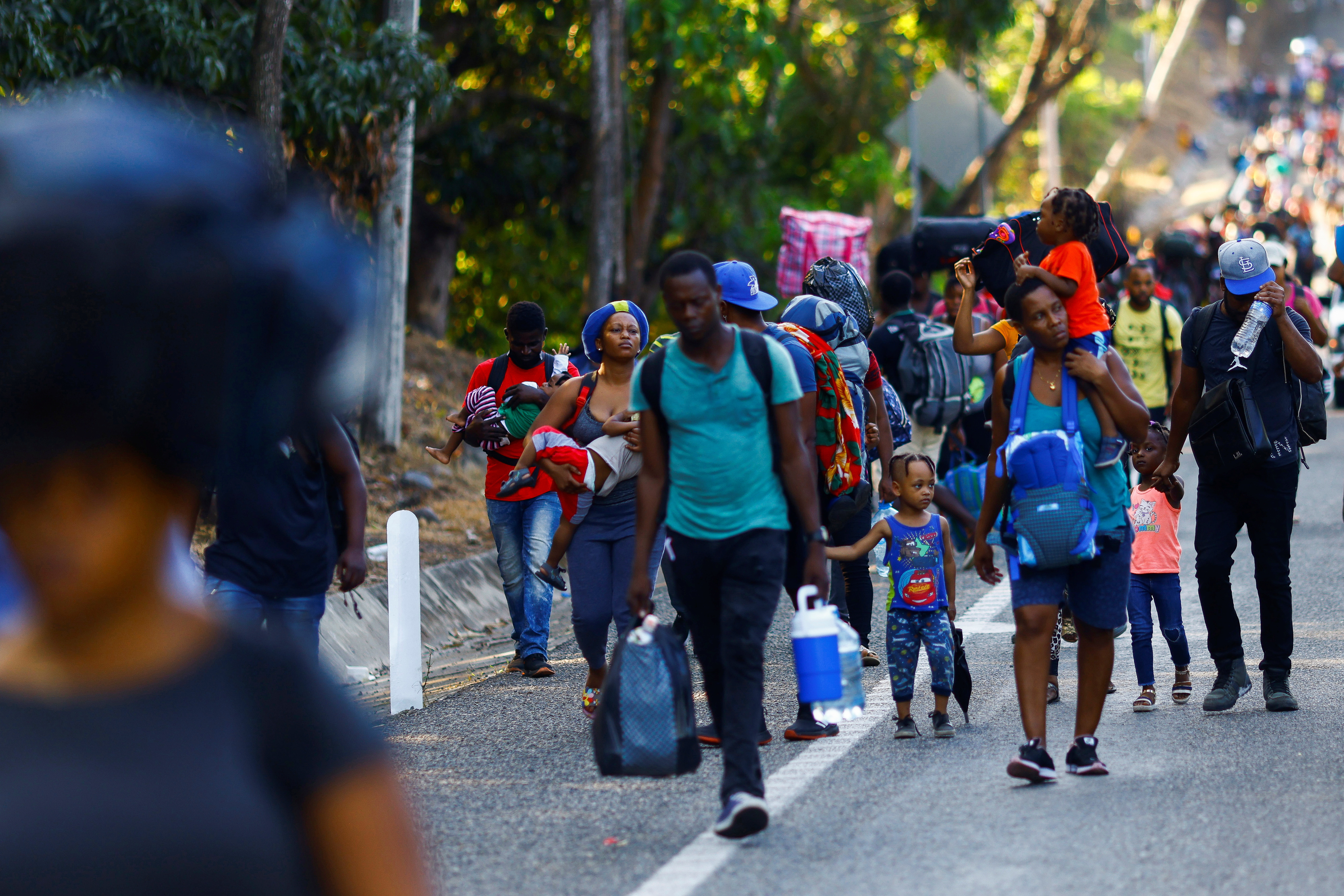 Migrants walk as they take part in a caravan heading to the U.S. border, near Huehuetan, Mexico November 29, 2021. REUTERS/Jose Luis Gonzalez
