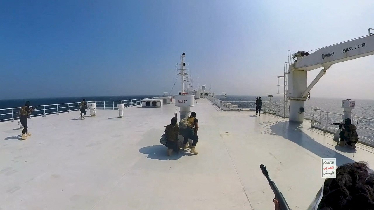 Houthi fighters take positions on the deck of the Galaxy Leader cargo ship in the Red Sea
