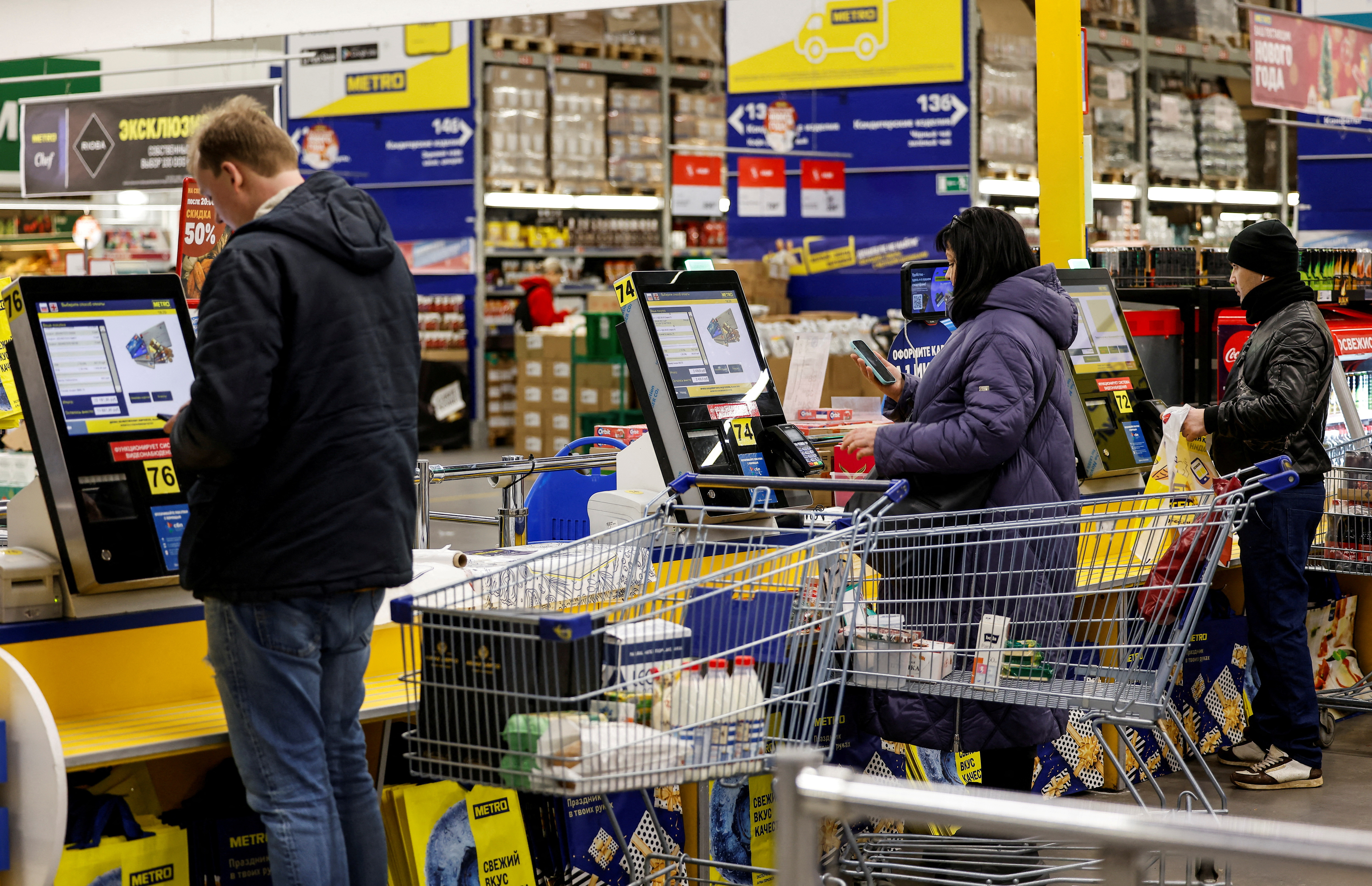 People shop at a Metro Cash and Carry hypermarket in Moscow