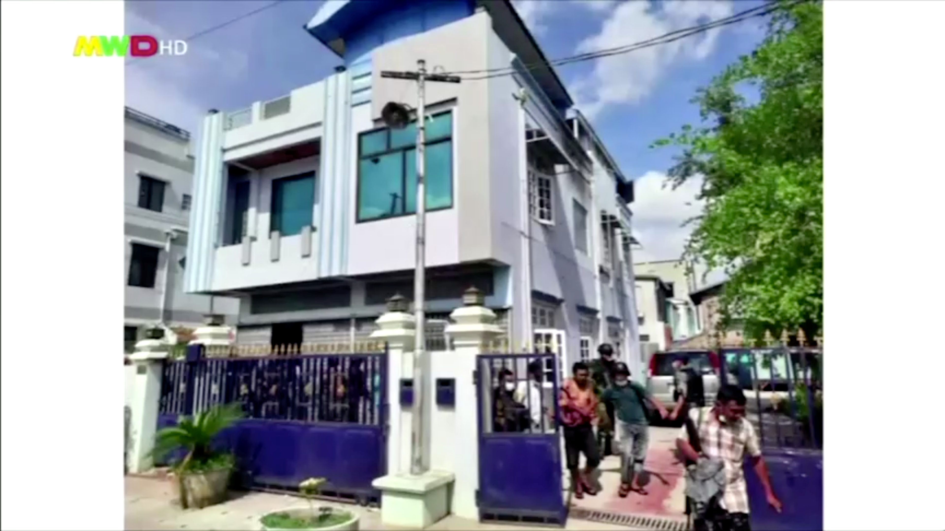 People walk out from a house believed to have been raided by security forces, in Mandalay