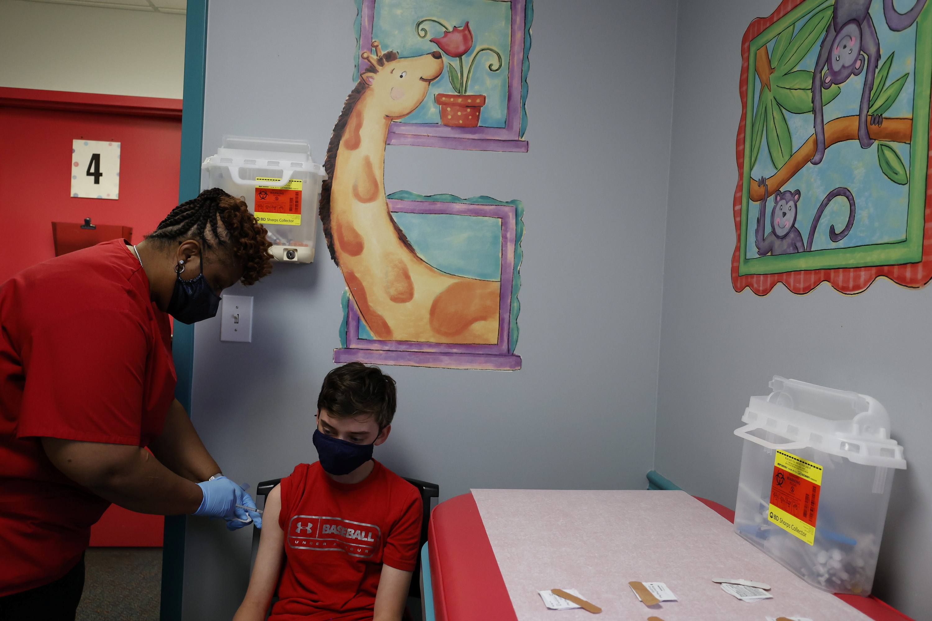 Aidan Mohl, 13, is inoculated with Pfizer's vaccine against coronavirus disease (COVID-19) by Registered Medical Assistant Melissa Dalton, after Georgia authorized the vaccine for ages over 12 years, at Dekalb Pediatric Center in Decatur