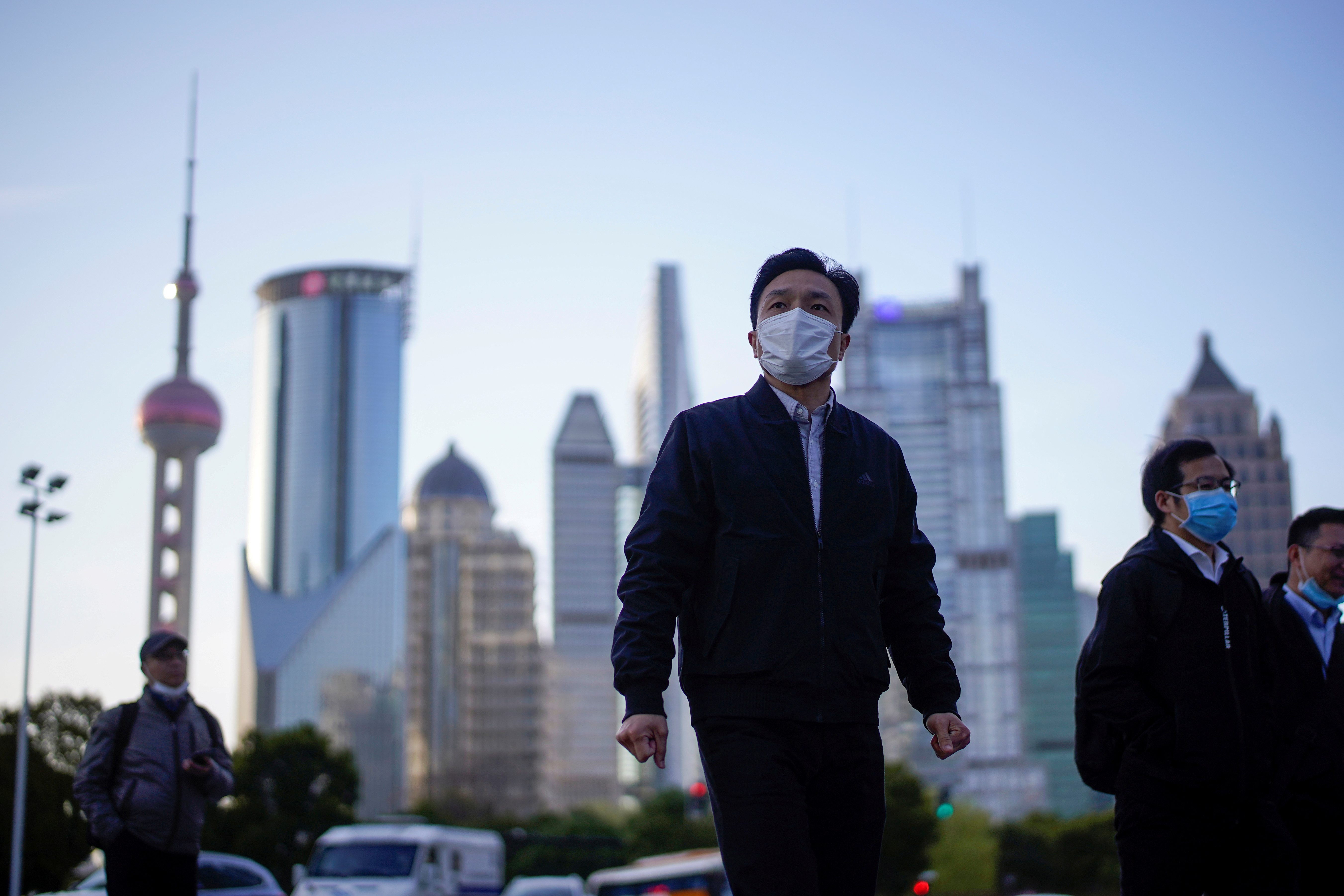 People wear protective face masks, following an outbreak of the novel coronavirus disease (COVID-19), at Lujiazui financial district in Shanghai