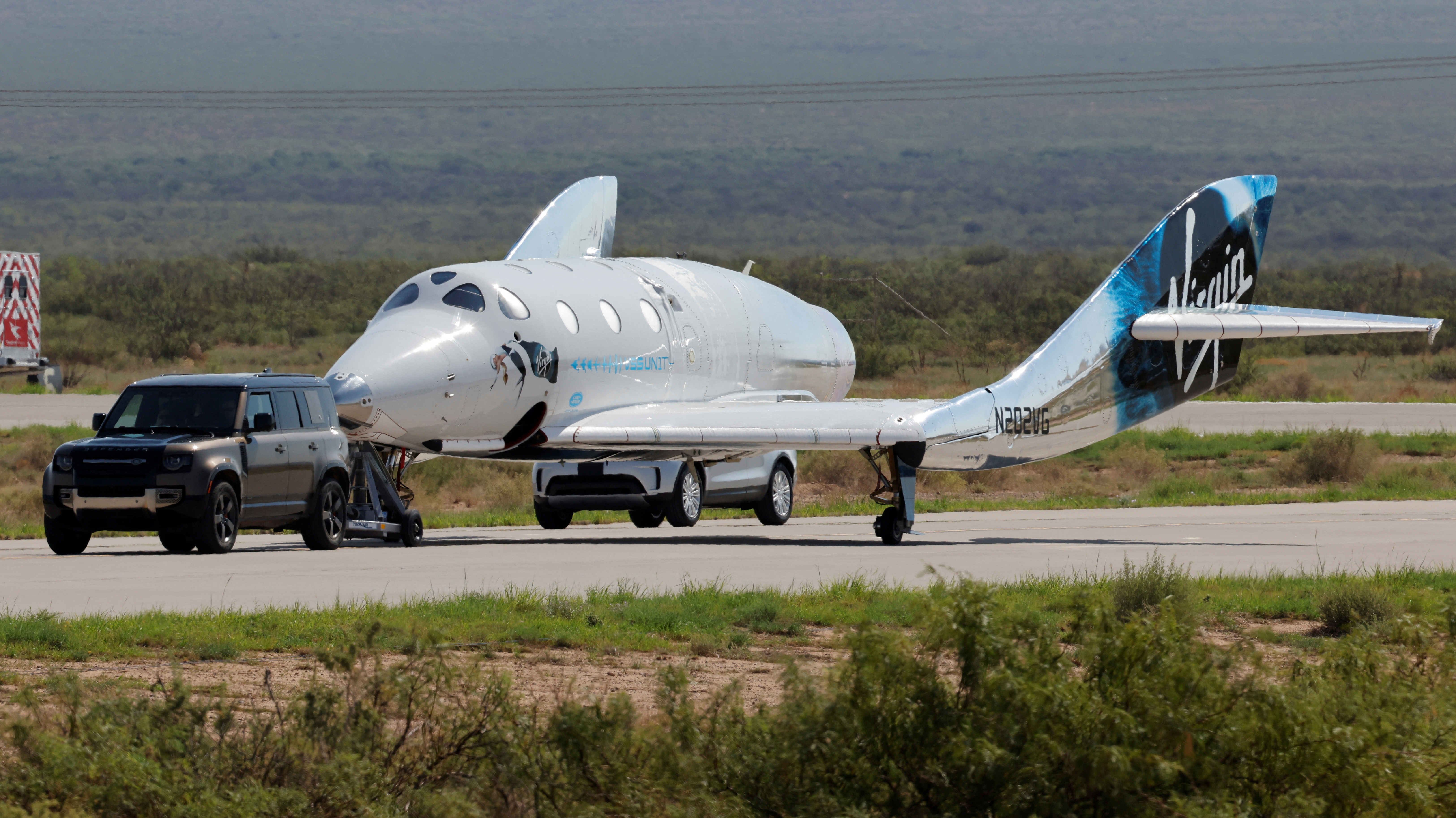 Virgin Galactic's passenger rocket plane VSS Unity is towed after reaching the edge of space above Spaceport America